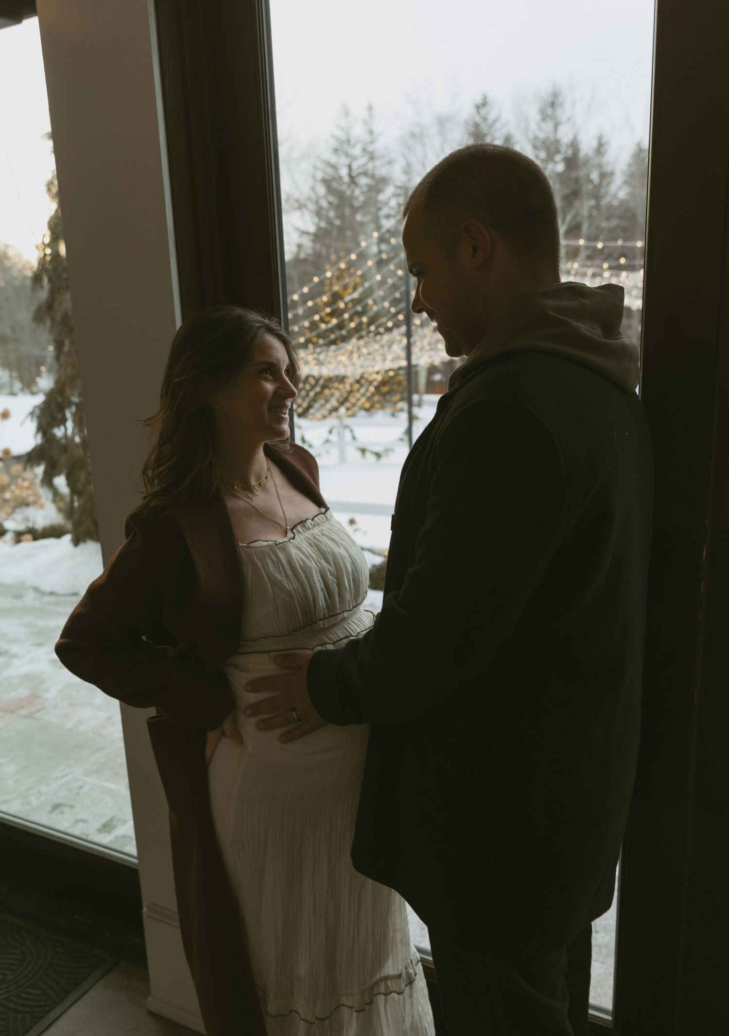 Cozy Editorial indoor maternity photos in the barn  at Cedar Lake Estates in Port Jervis, New York. Photo indoor with string lights of patio