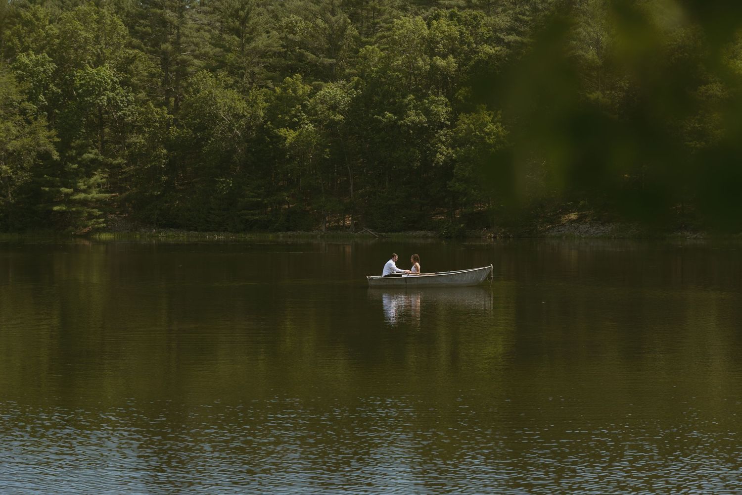 cinematic Couple photo in a canoe in a pond near the Delaware River in the Catskill Mountains of New York during the summer