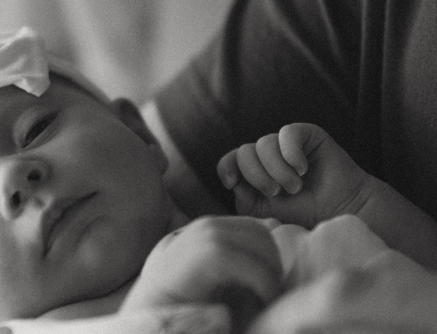 Catskill Mountains newborn photo in-home. Mom and dad holding newborn baby. Natural light.