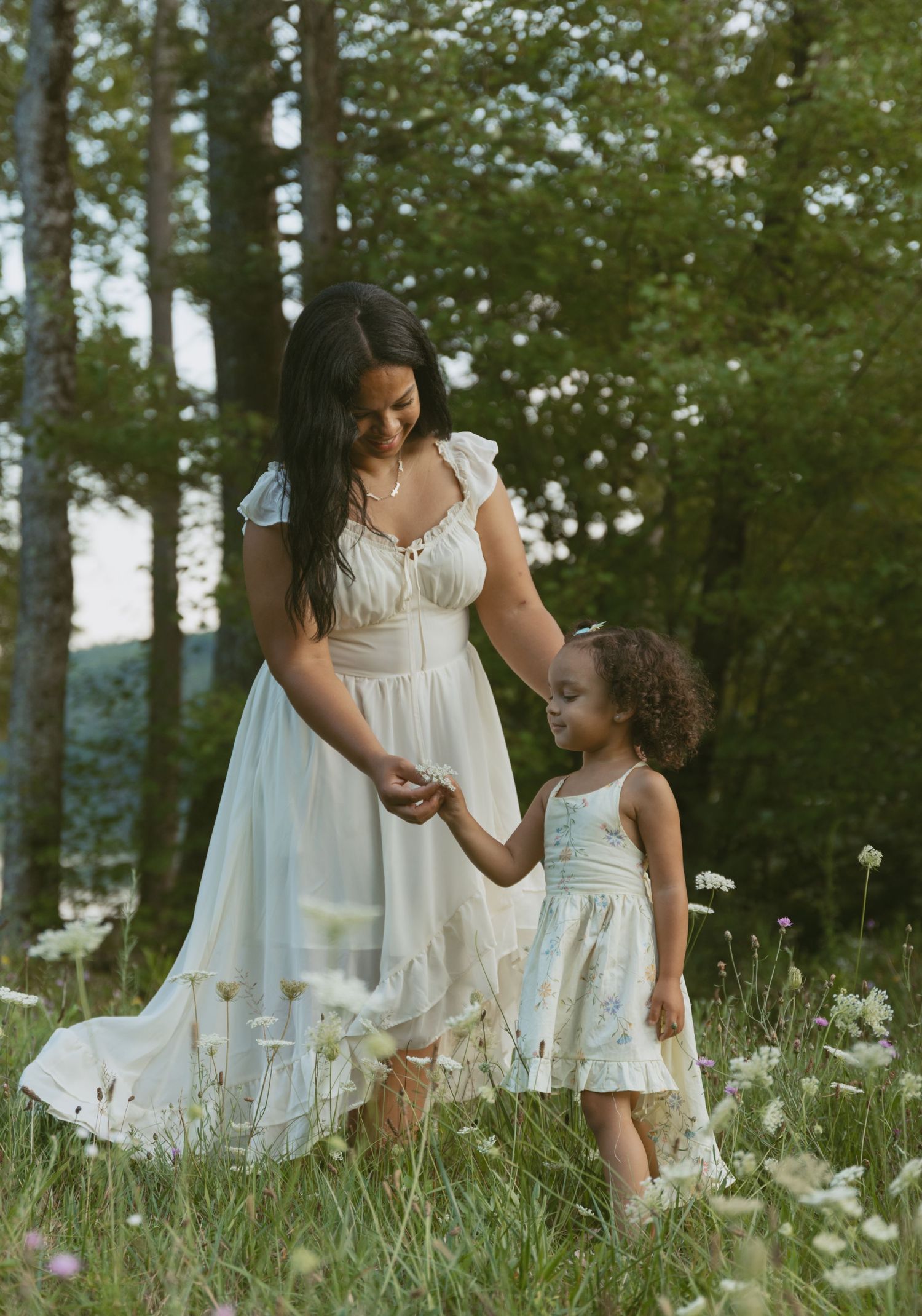 Family photos in Sullivan County New York, Catskills. Mom and daughter picking flowers in field