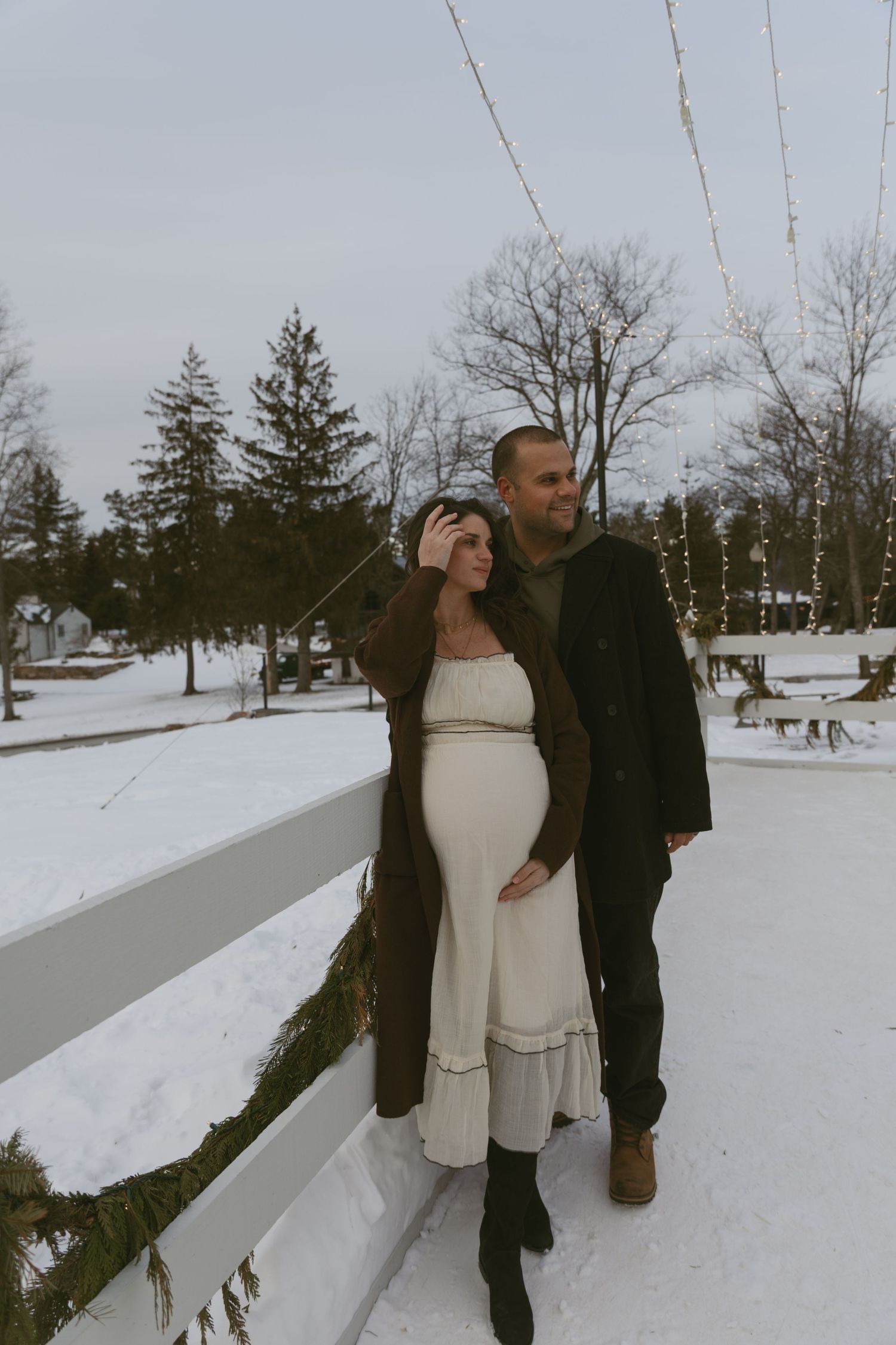 Cozy Editorial indoor maternity photos on the barn patio at Cedar Lake Estates in Port Jervis, New York. Under the string lights in winter