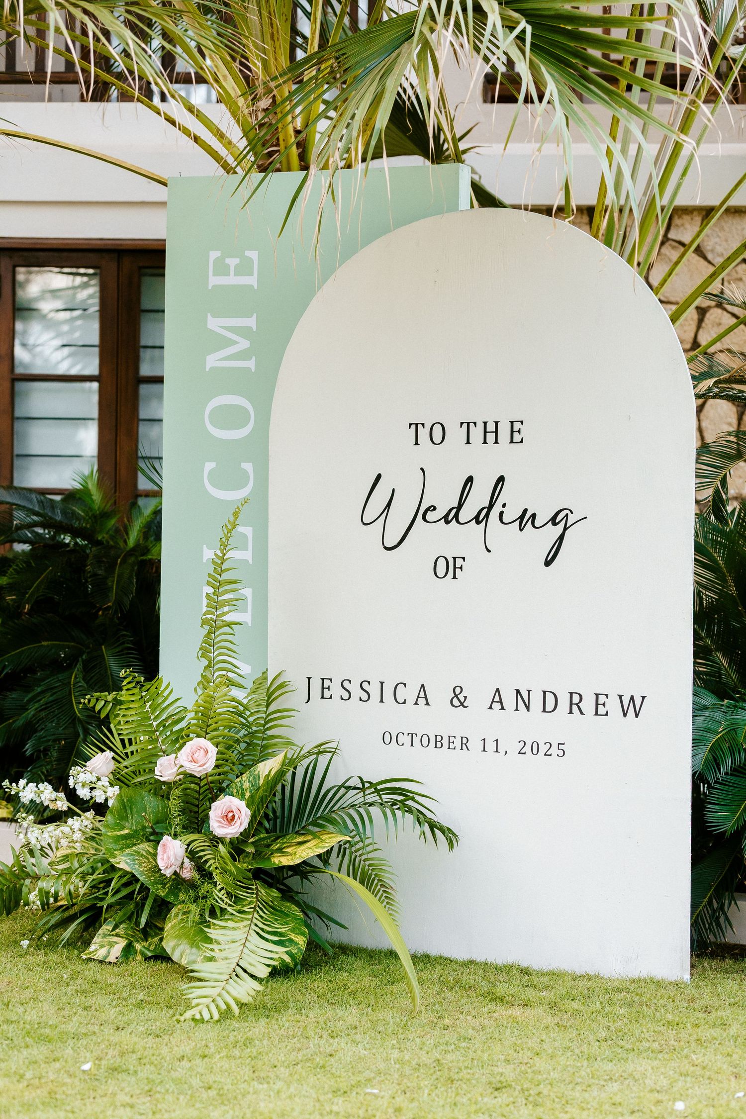 Elegant wedding welcome sign for Jessica & Andrew, October 11, 2025, with tropical floral arrangements.