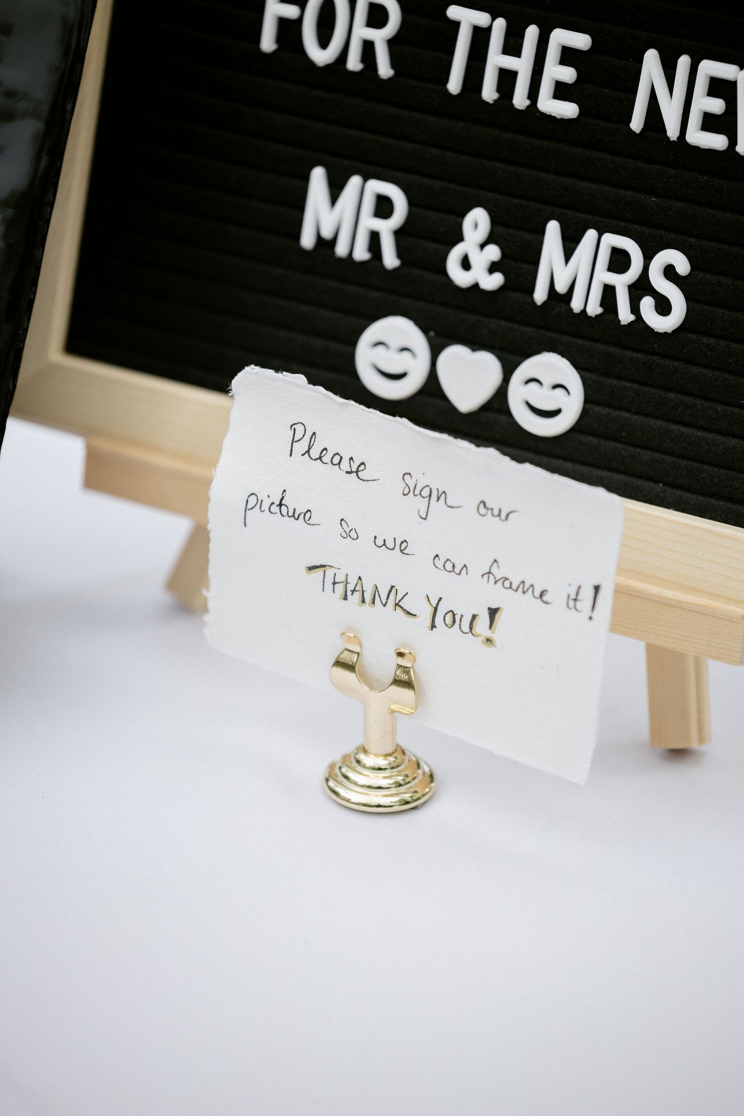 Wedding sign asking guests to sign a picture for the new Mr. and Mrs. to frame as a keepsake.