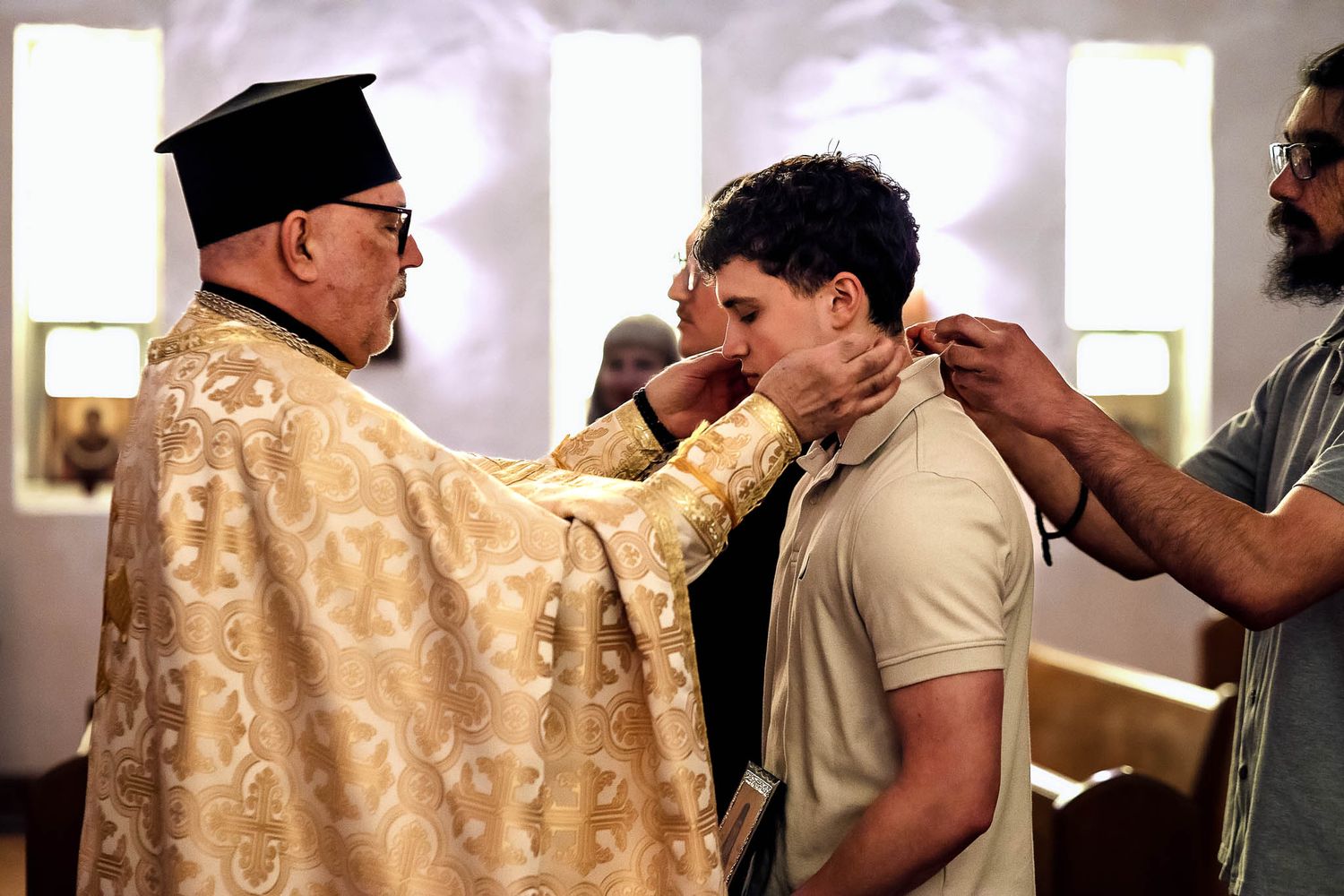 Close-up of an Orthodox priest performing anointing with Holy Myrrh on the forehead.