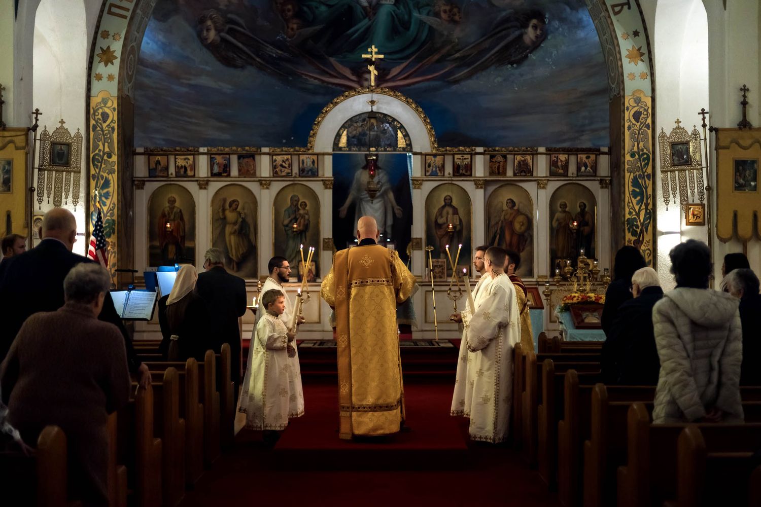 A detail of an Orthodox sanctuary in Western New York, showcasing a quiet, reverent moment during a service.