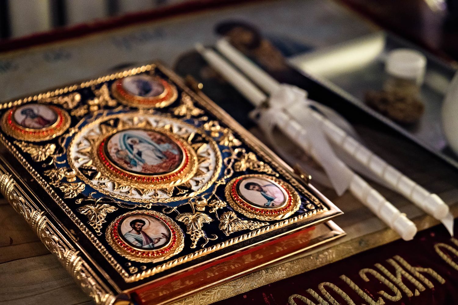 The Holy Gospel and liturgical items resting on a table in an Orthodox church.