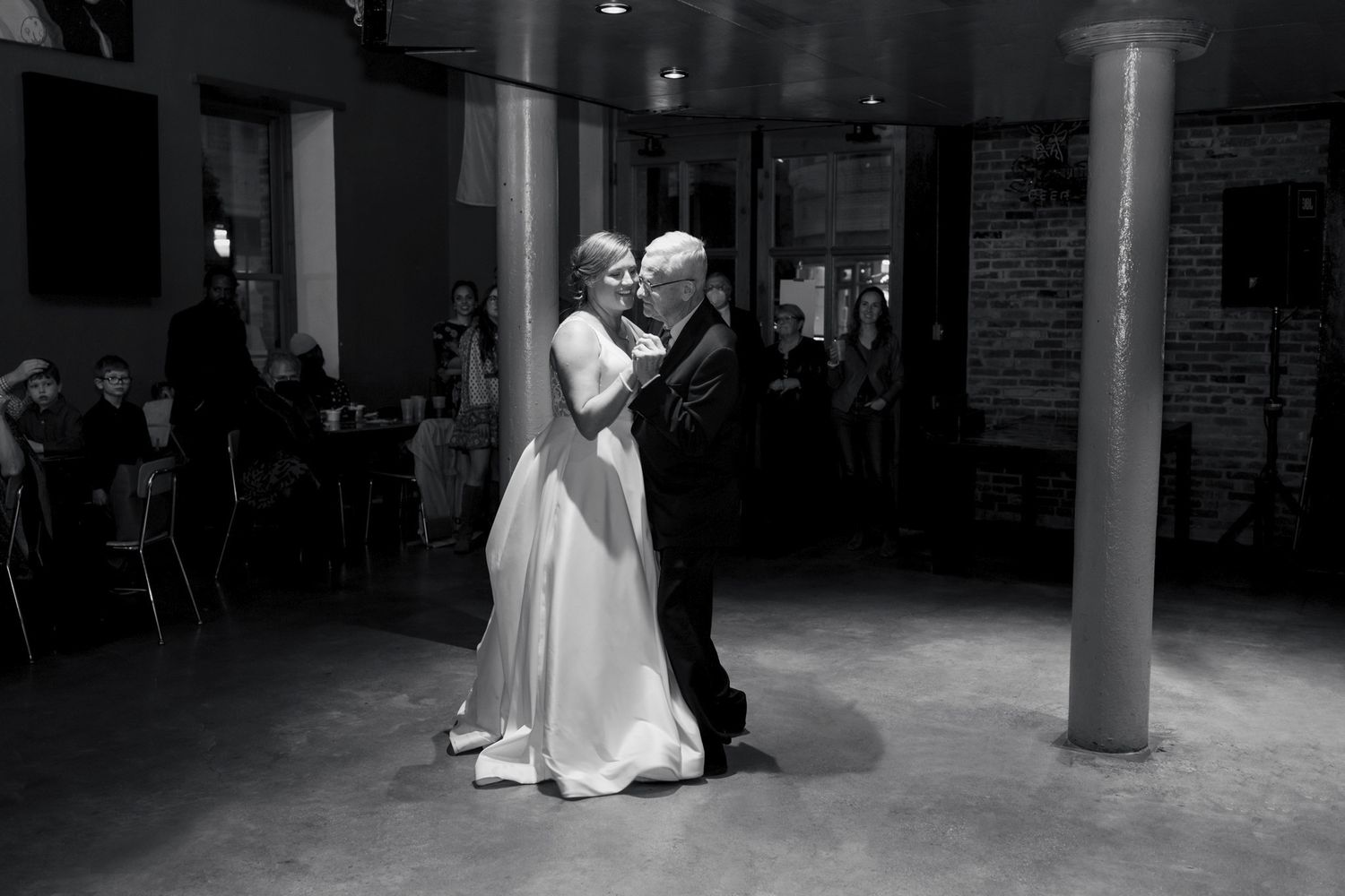 Father and daughter sharing a dance during an Orthodox wedding reception.