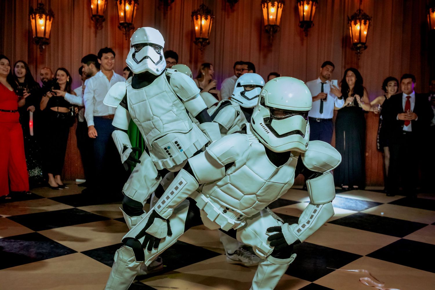 Two Star Wars Stormtroopers performing a dance routine on a wedding reception dance floor.
