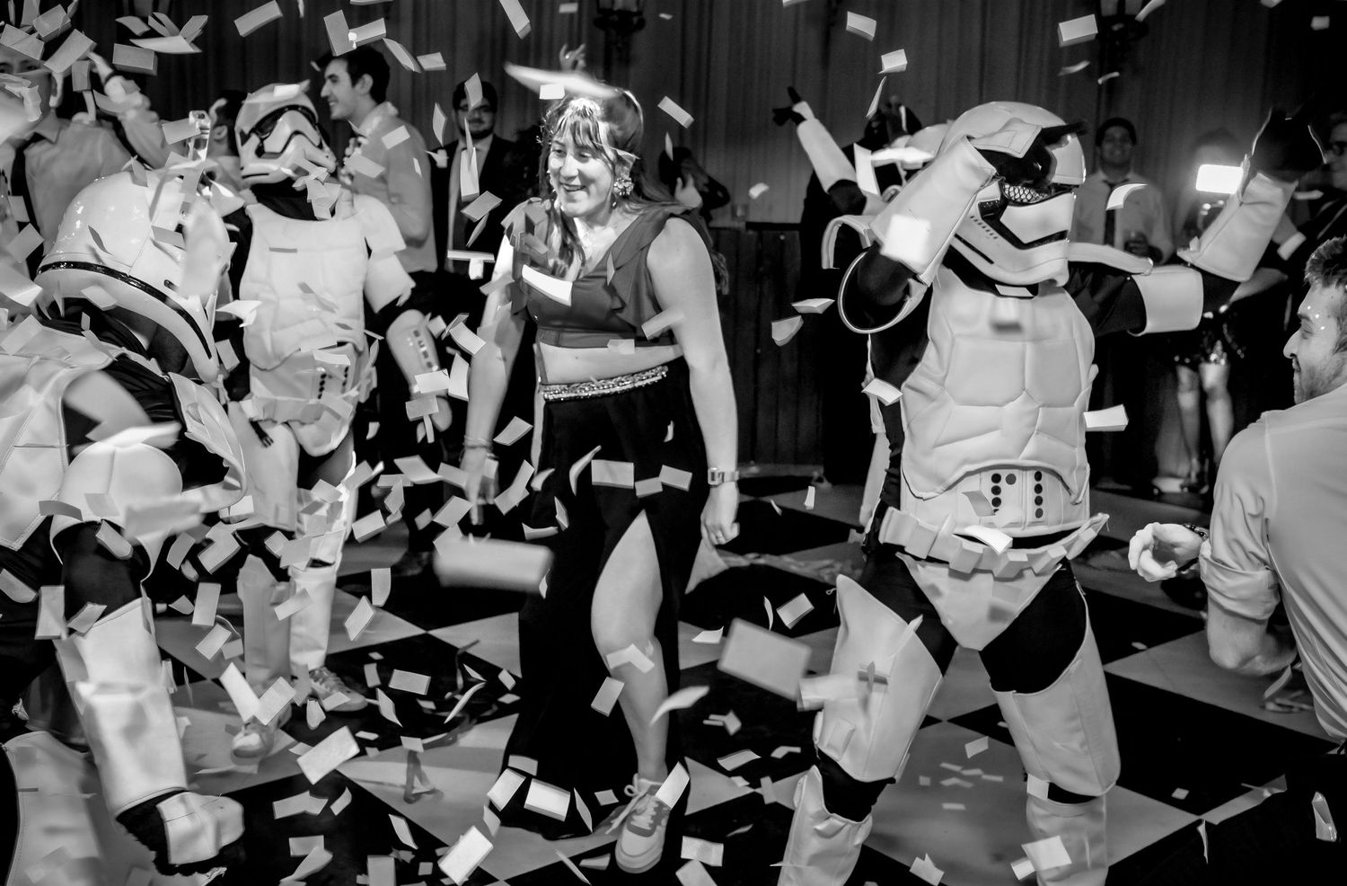 Confetti fills the air as guests dance alongside Stormtroopers at a Star Wars wedding.
