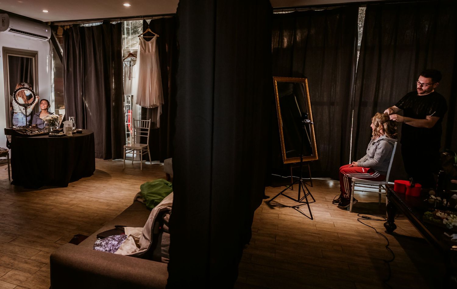 A bridal preparation room with two people getting hair and makeup done simultaneously.