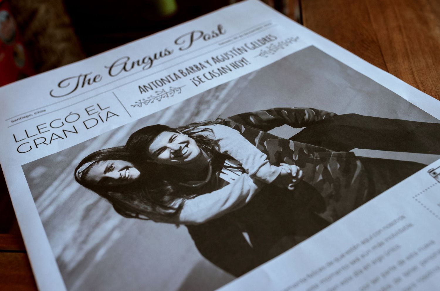 Close-up of The Angus Post wedding newspaper featuring a couple's engagement photo on the front page.