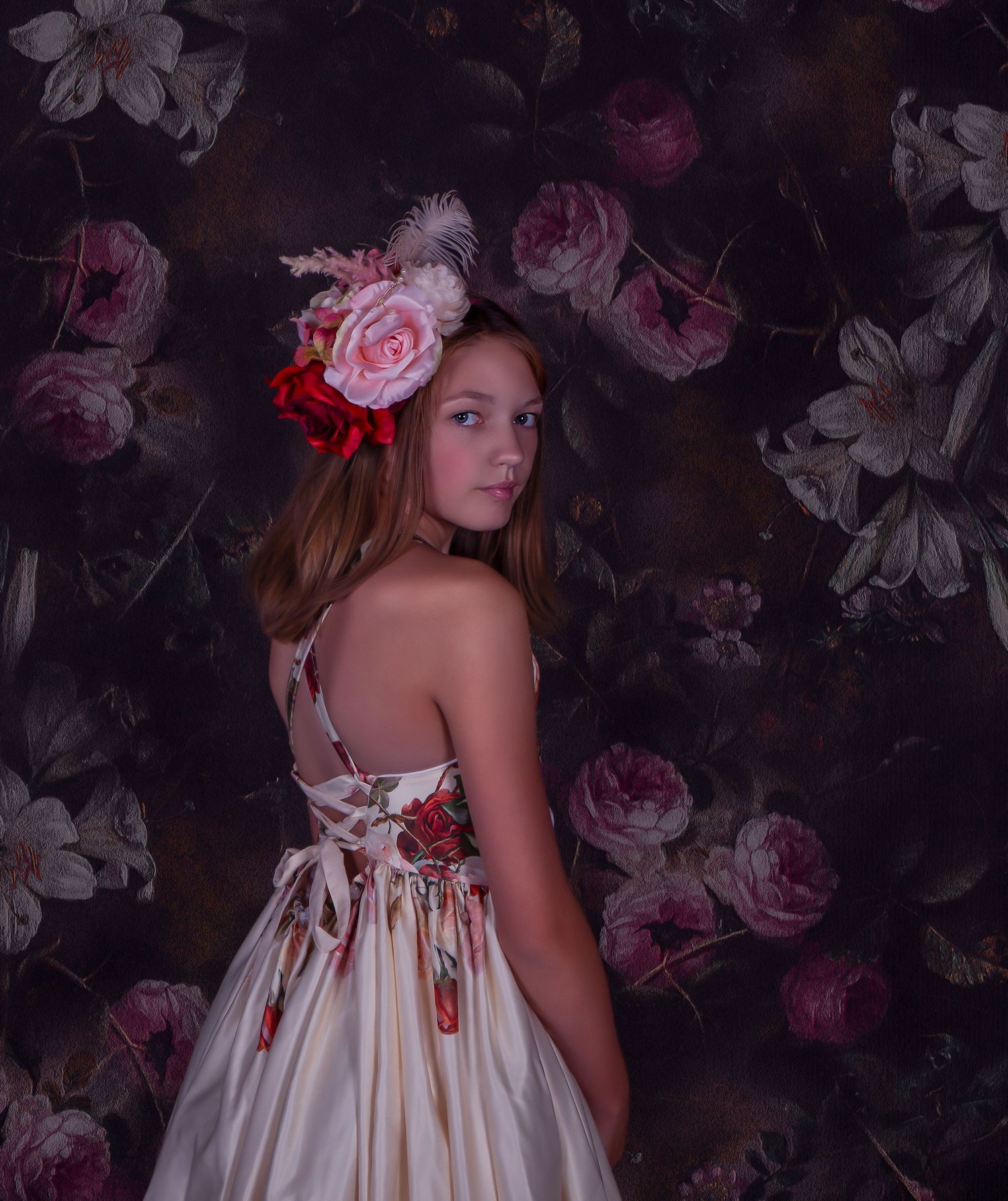 Romantic floral backdrop with white dress and pink rose accents.