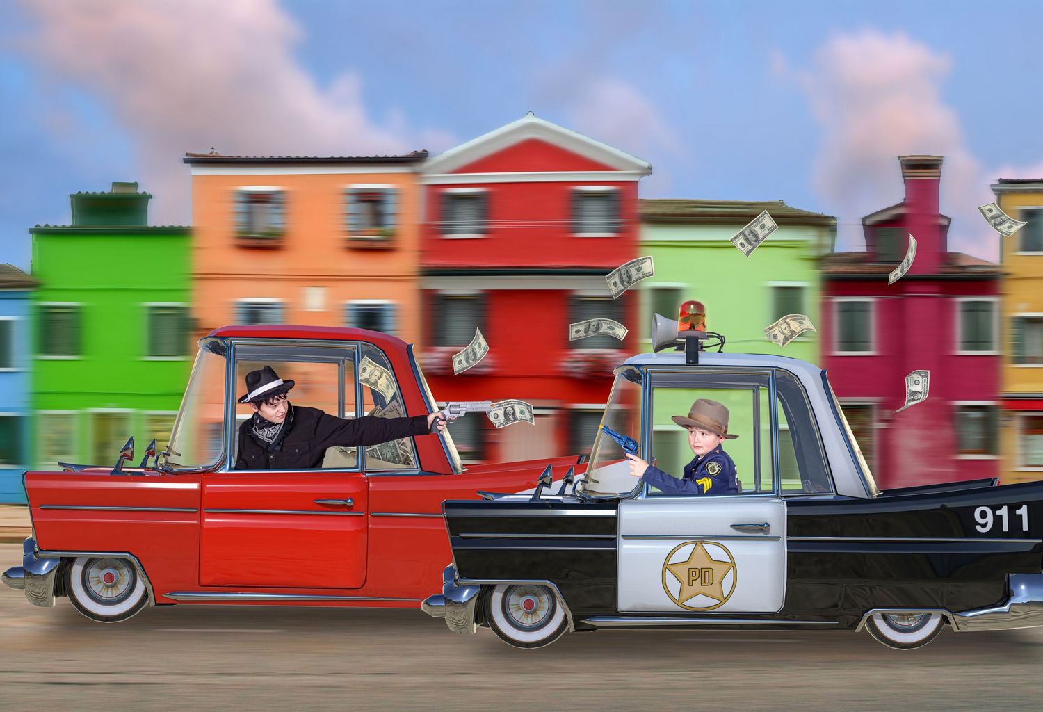 Vintage police cars from different eras line up in a colorful display against vibrant buildings.