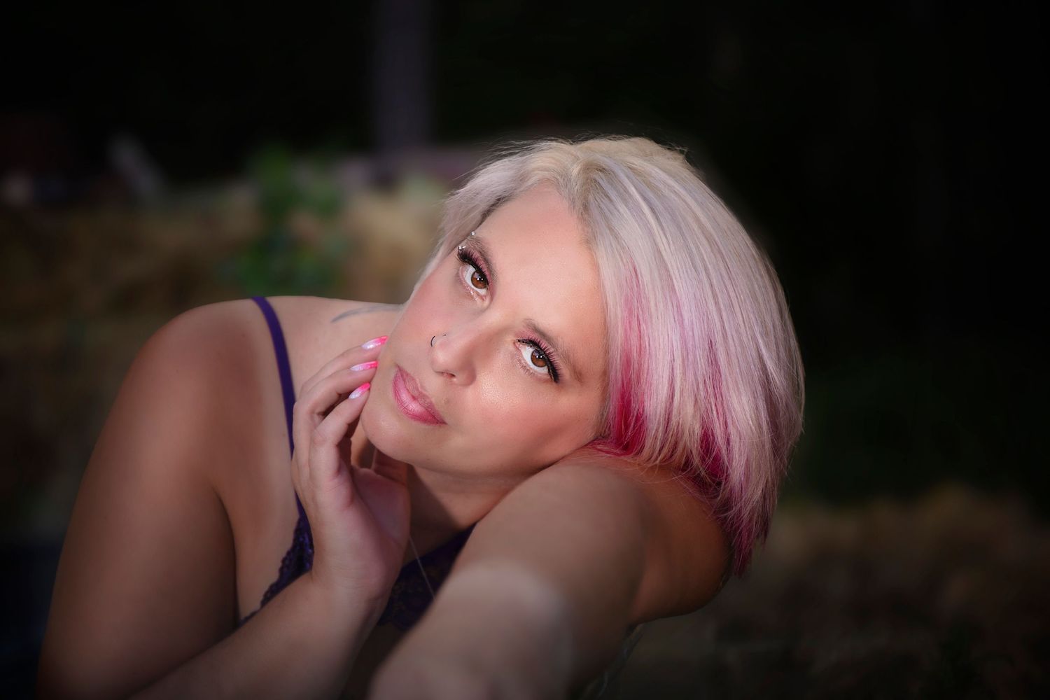 Pink-tinted artistic portrait with soft focus and natural lighting.