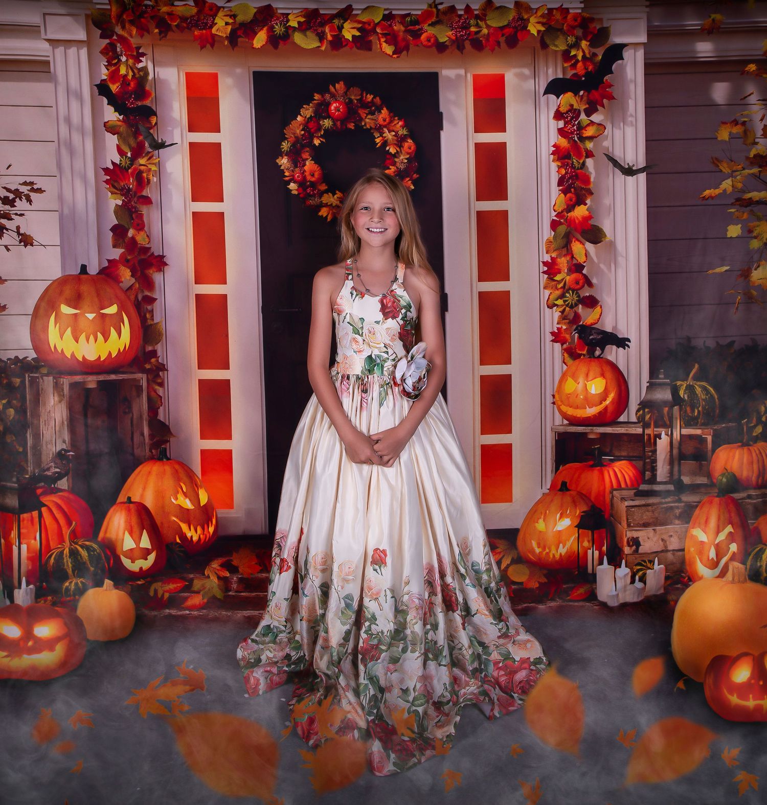 Halloween porch scene with carved pumpkins, autumn leaves, and white floral dress.
