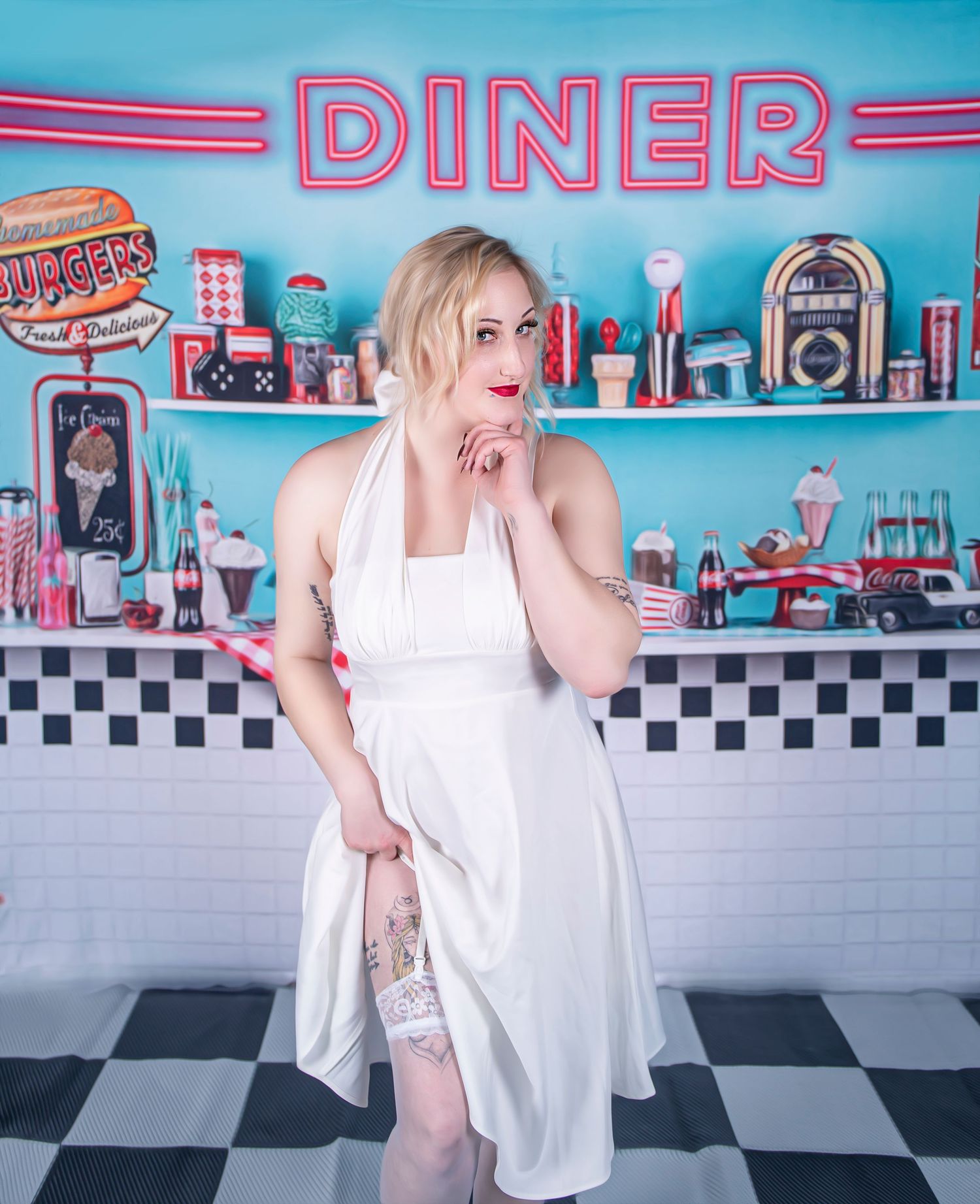 Vintage diner themed photoshoot with retro americana decor and checkered floor.