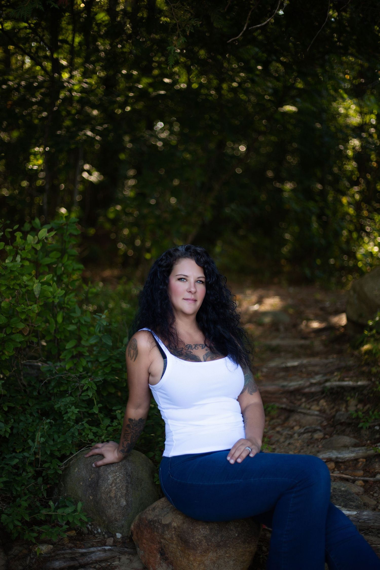 Natural outdoor portrait session in a wooded setting with soft lighting.
