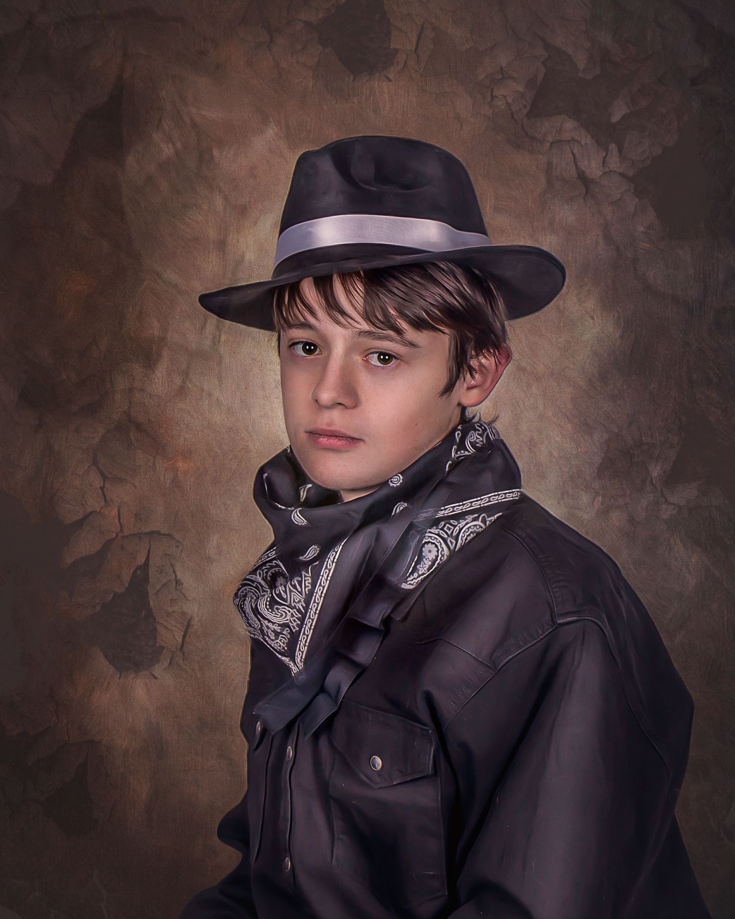 A person wearing a black cap and jacket poses against a dark textured backdrop in a dramatic studio portrait series.