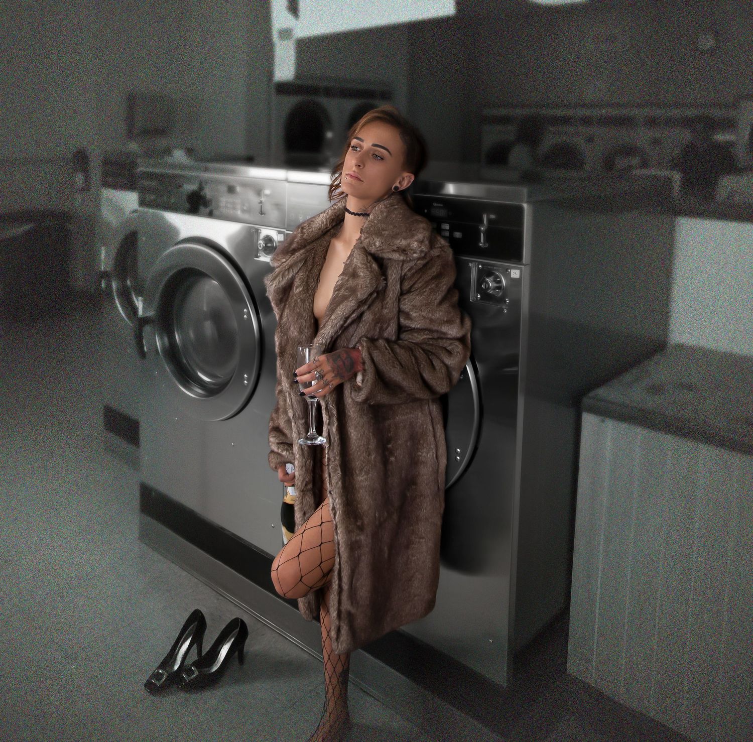 Moody black and white photo series in an empty laundromat with dramatic lighting.