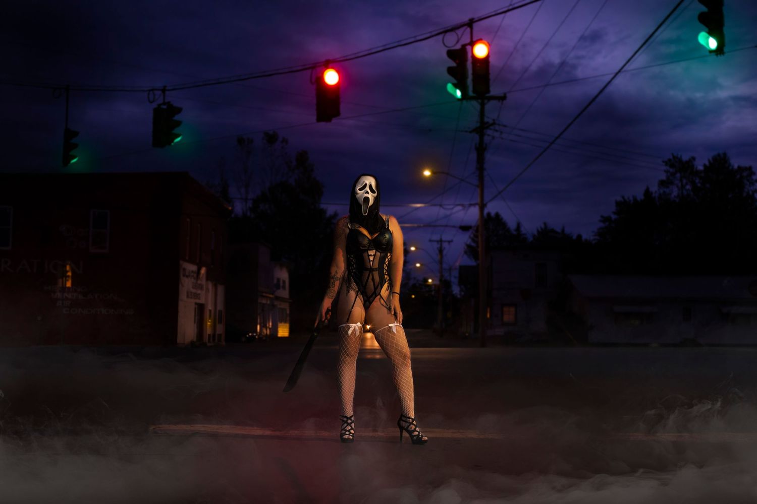 Nighttime street scene with traffic lights and moody lighting.