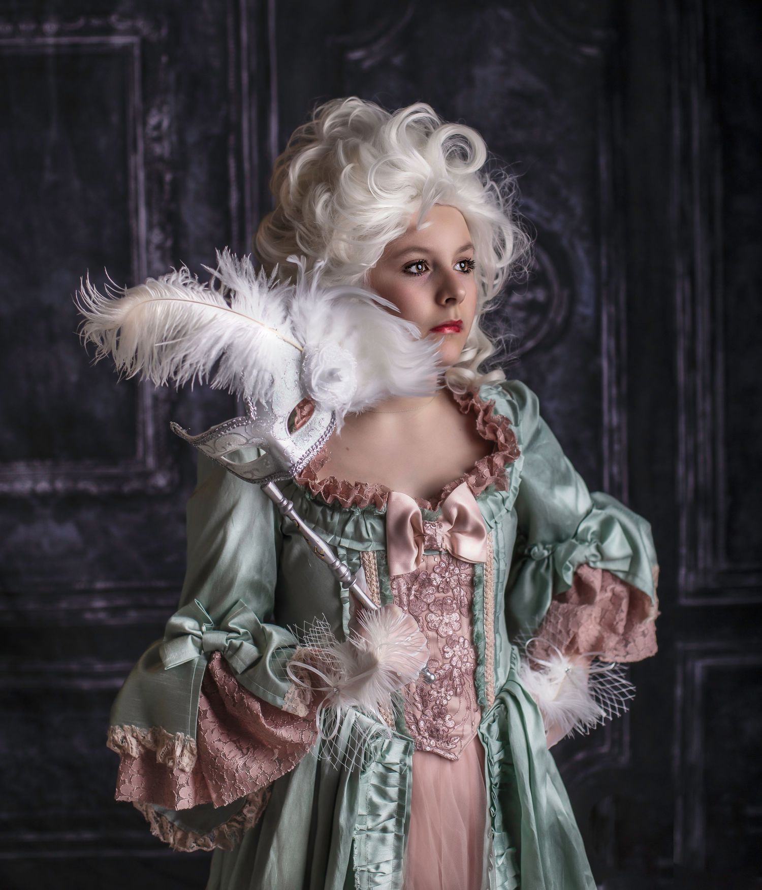 Baroque-inspired fashion photography with mint green and pink period costumes against dark background.
