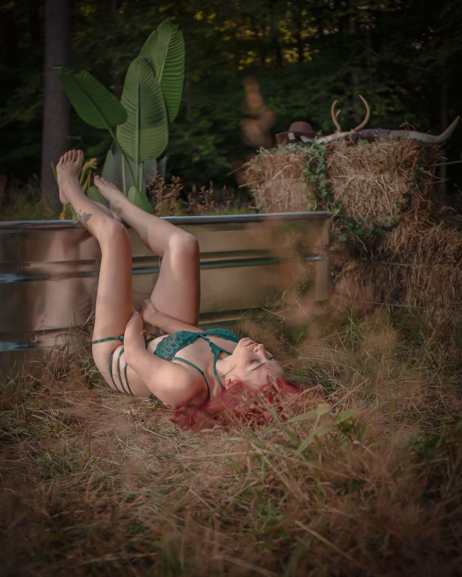 Artistic outdoor portrait among tropical plants and natural scenery.