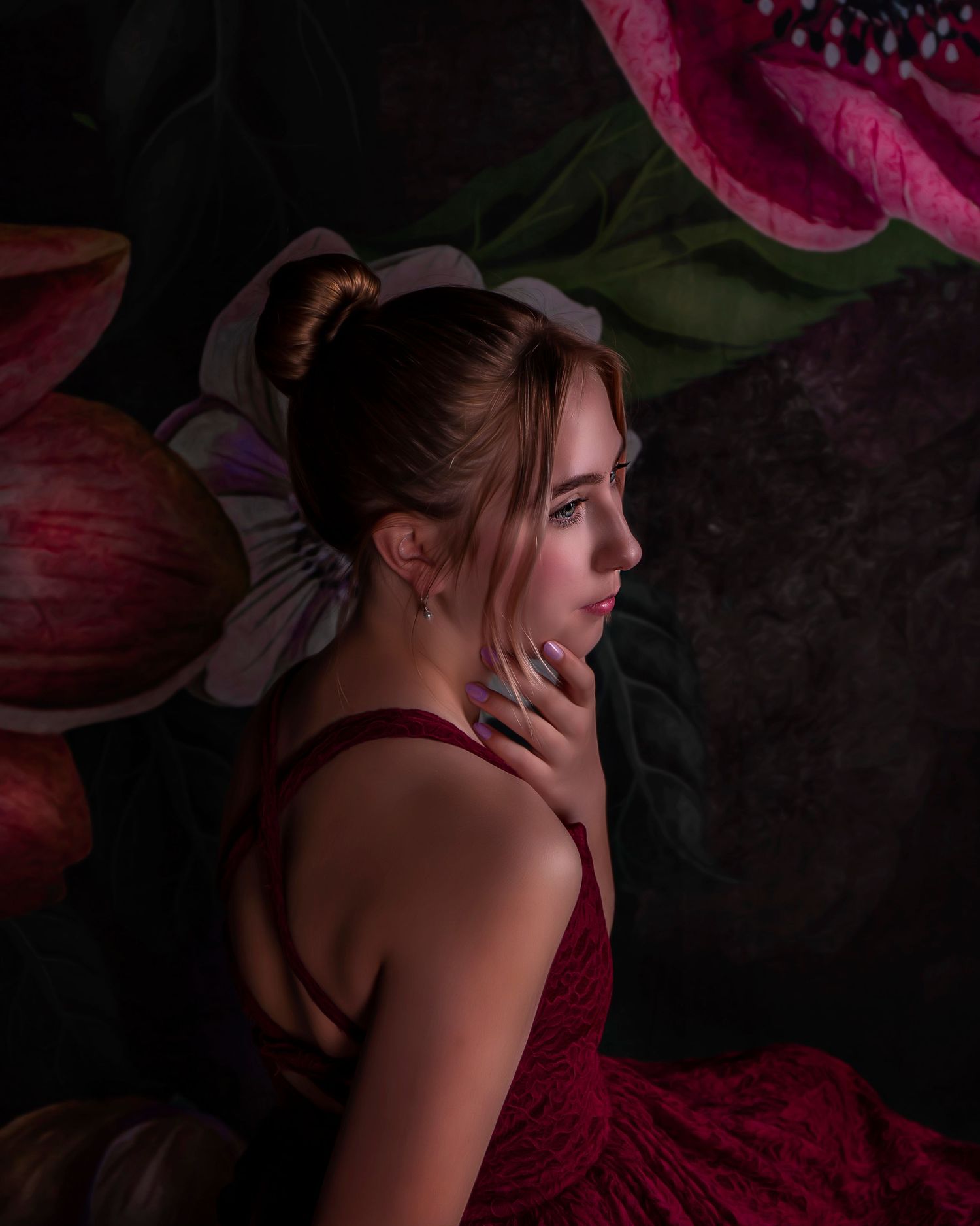 Moody boudoir scene with burgundy dress and dramatic lighting.