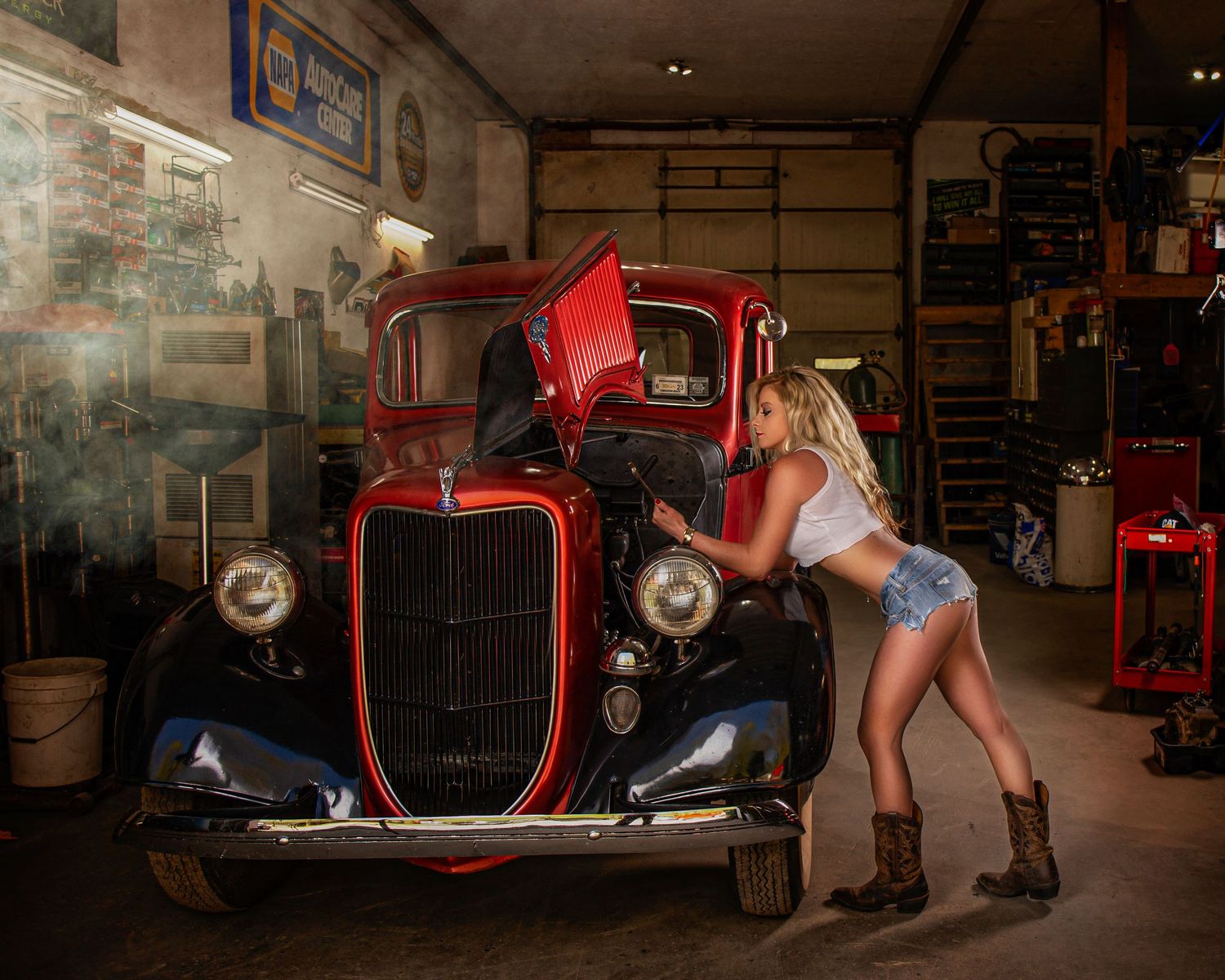 Vintage car photoshoot in an old garage with classic red automobile.