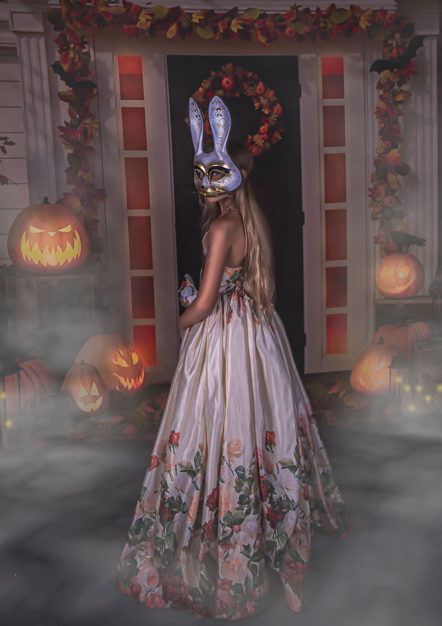 Spooky Halloween scene with fog, jack-o-lanterns, and floral dress on decorated porch.