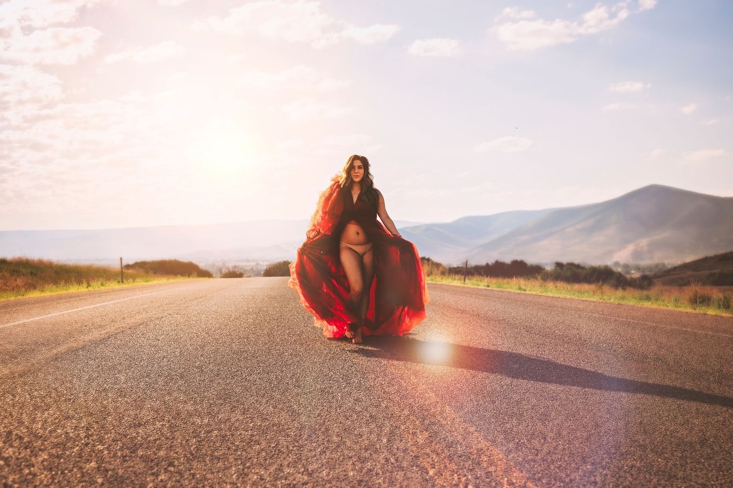Artistic sunset photography on empty road with lens flare effects.
