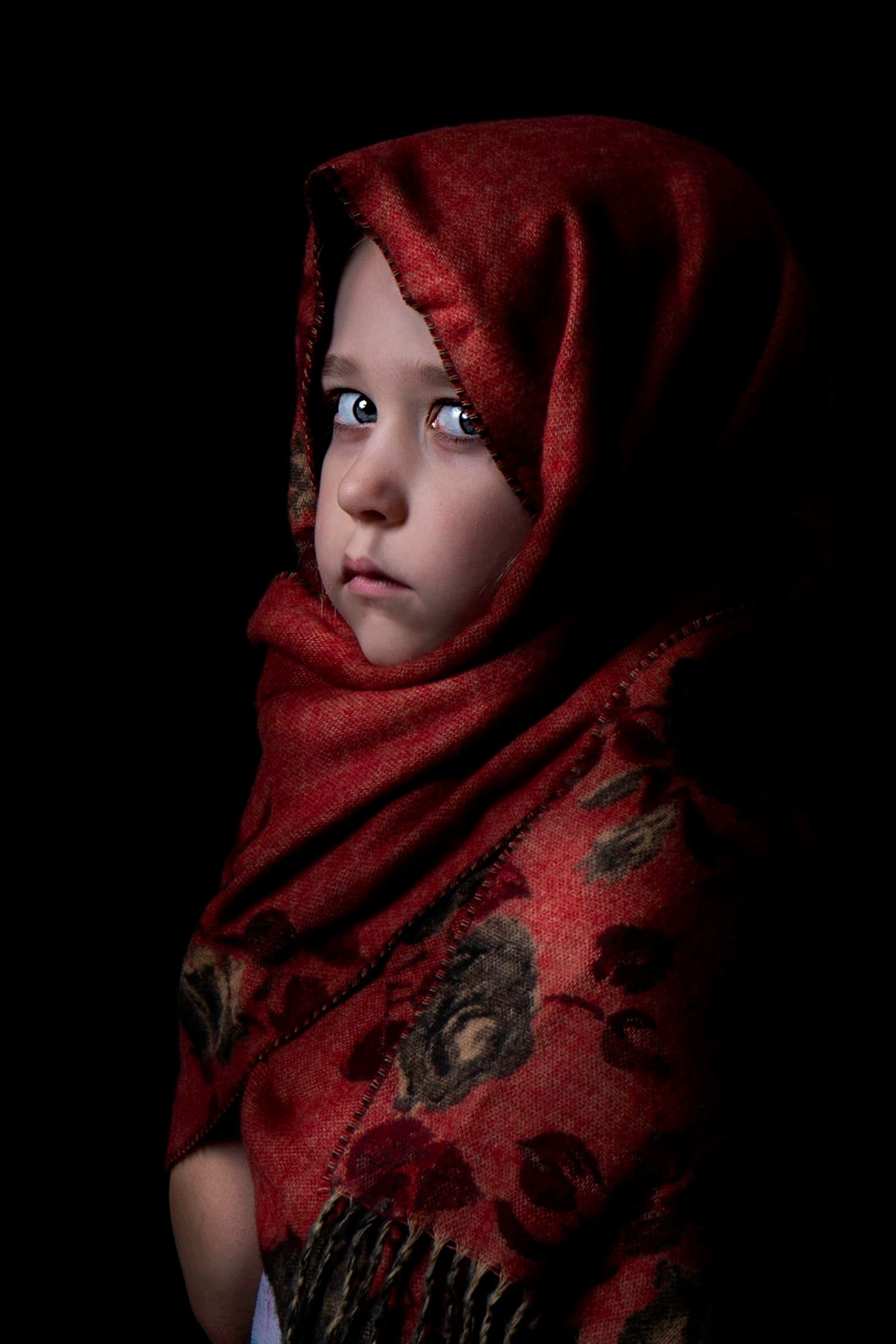 Dramatic portrait series featuring a red scarf against dark background creating a mysterious atmosphere.