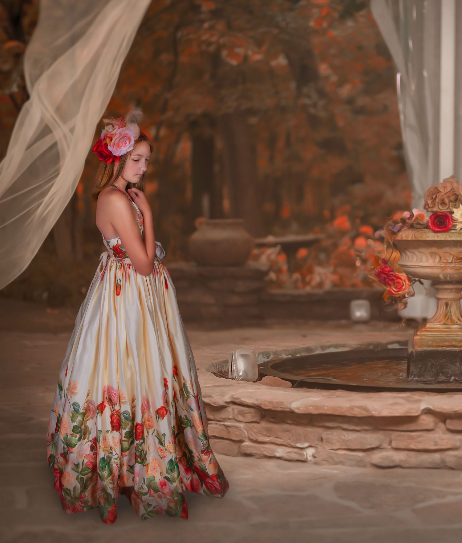 Elegant floral dress detail against stone wall in outdoor setting.