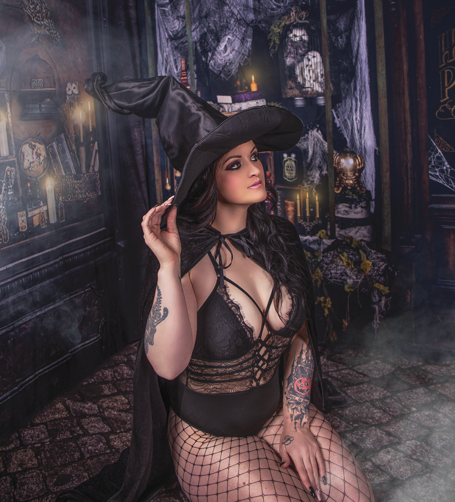 Gothic-inspired photoshoot in dark alley with vintage street lamps and moody atmosphere.