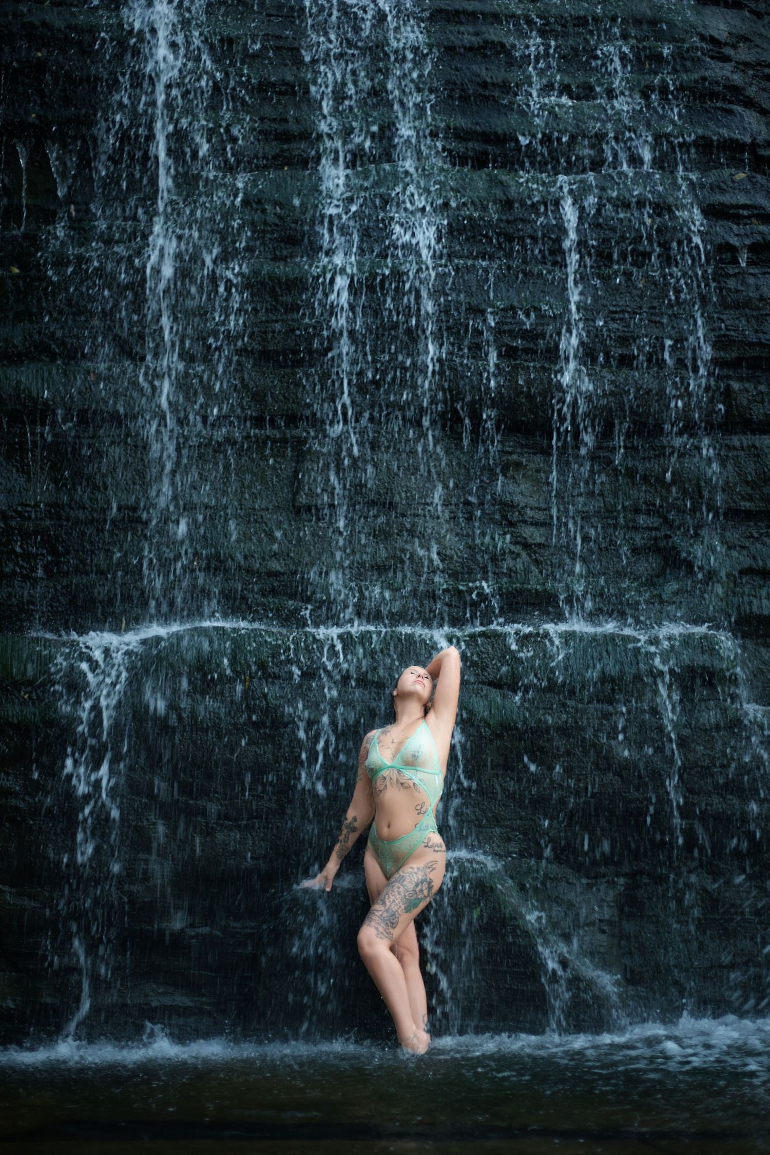 Dramatic waterfall photography series with water streaming down dark rock face.