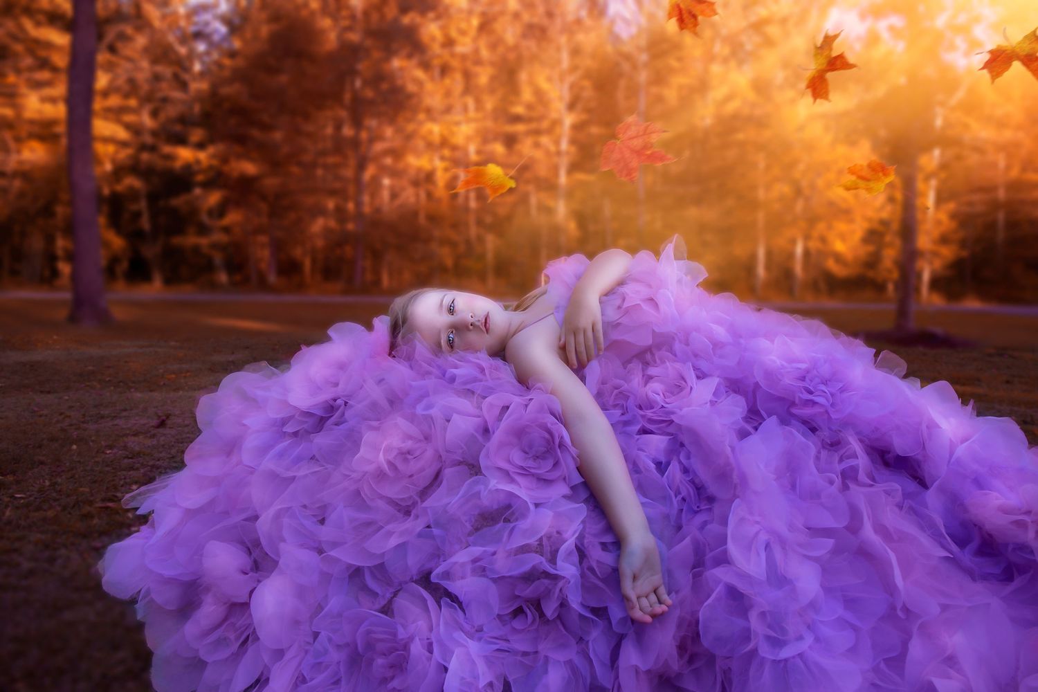 Dramatic sunset portrait session with flowing purple dress and golden light.