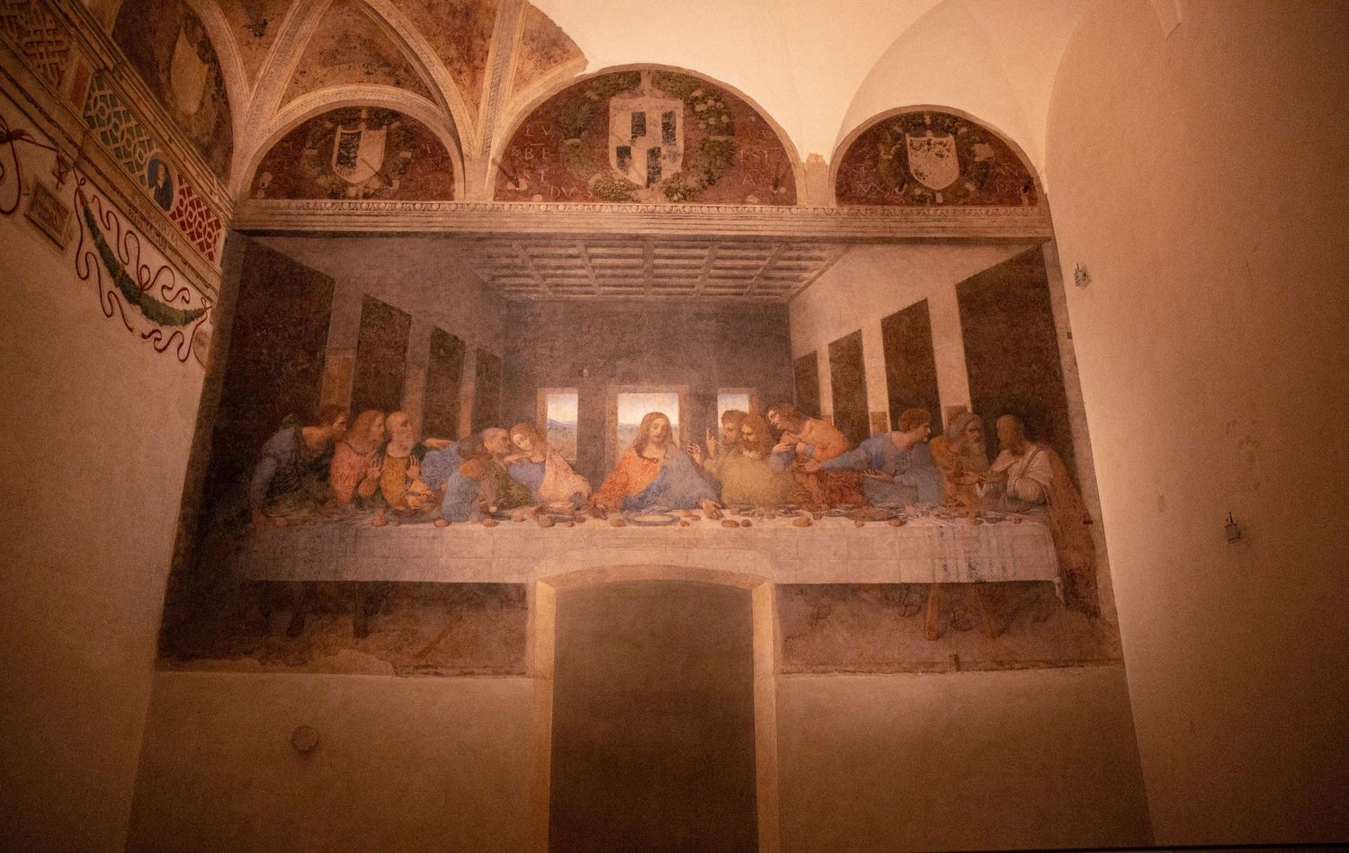 A panoramic view of ornate medieval frescoes adorning the walls and arches of an ancient church interior.