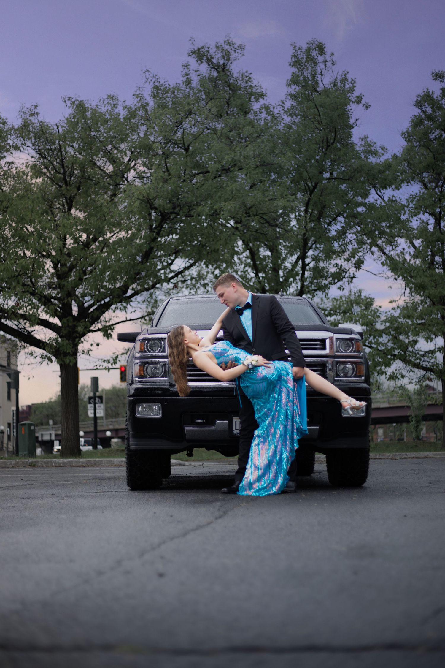 Artistic photo sequence showing a person in blue dress lying against a black truck at sunset.