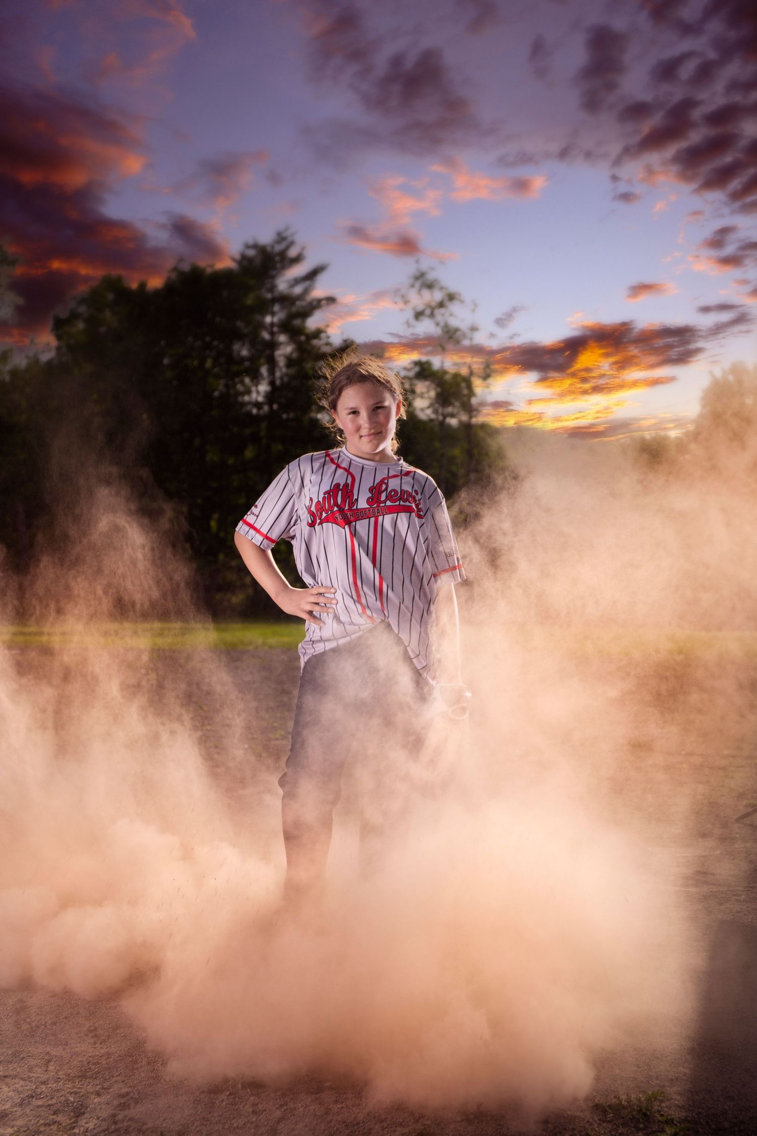 Dramatic dust cloud effect during outdoor sports photography session at sunset.