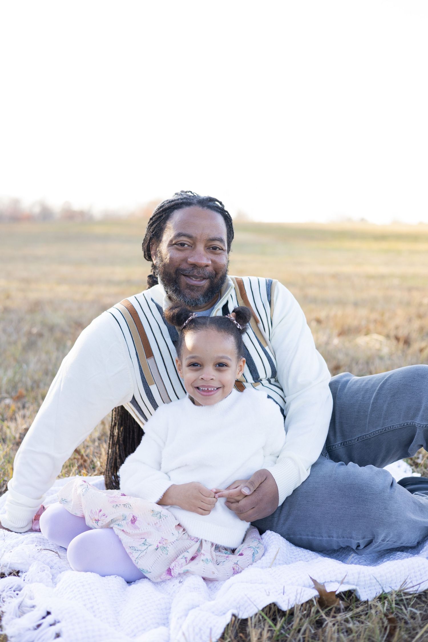 Family sharing joyful moments during outdoor portrait session at golden hour.