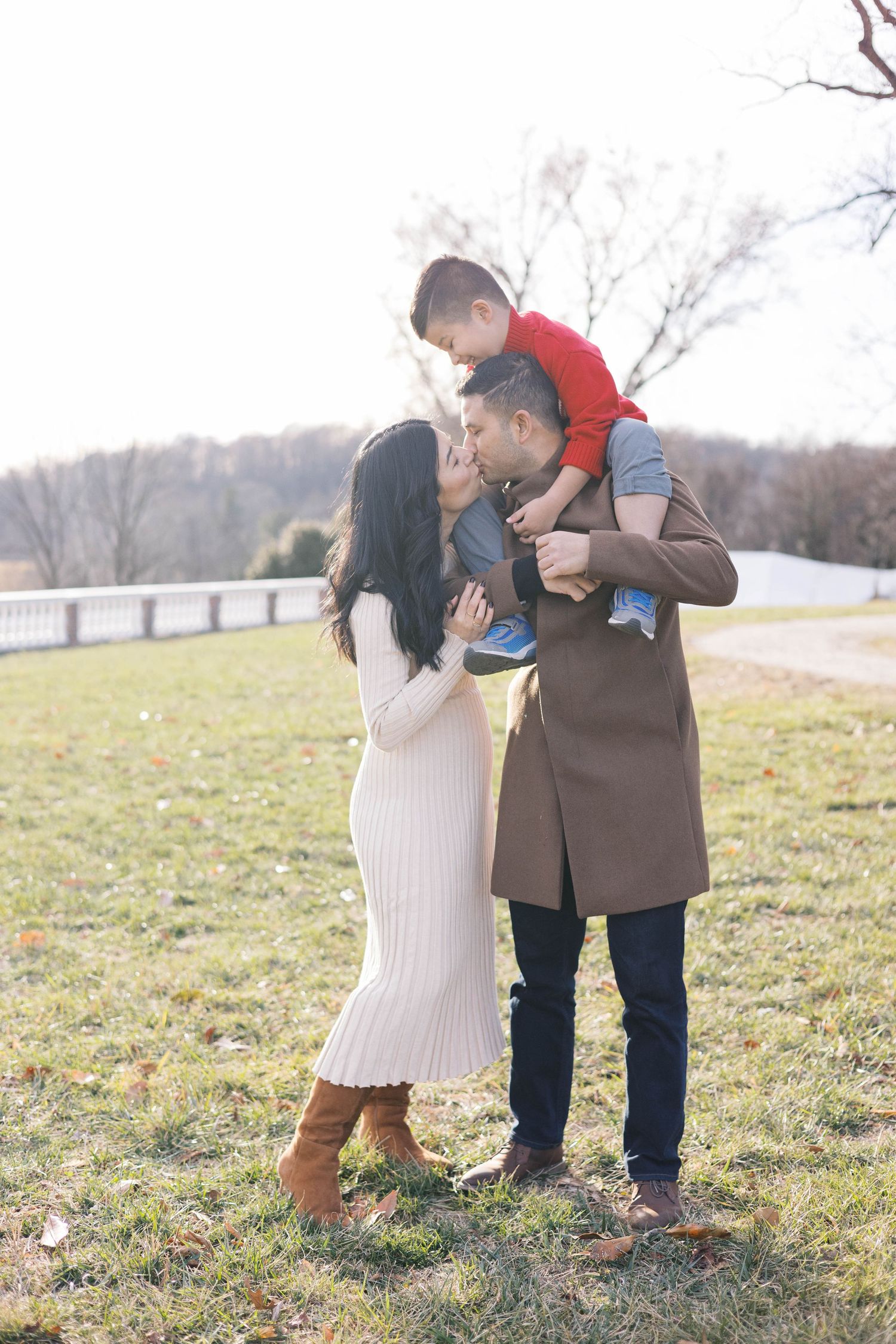 An intimate family portrait session taking place in a scenic outdoor setting.