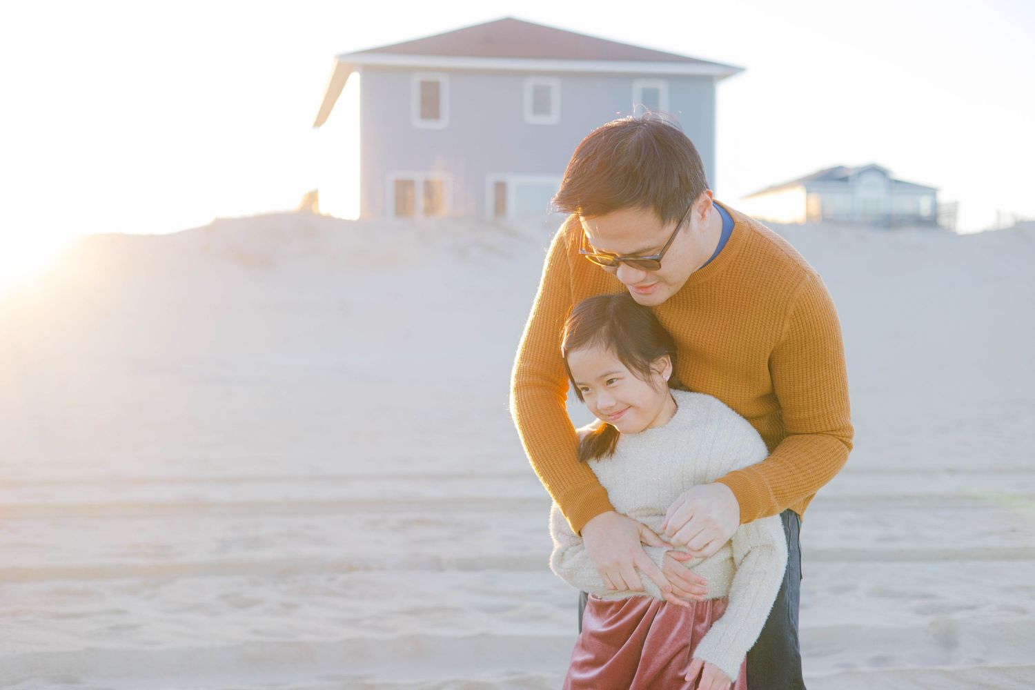 A sweet bonding moment between two people at sunset on the beach.