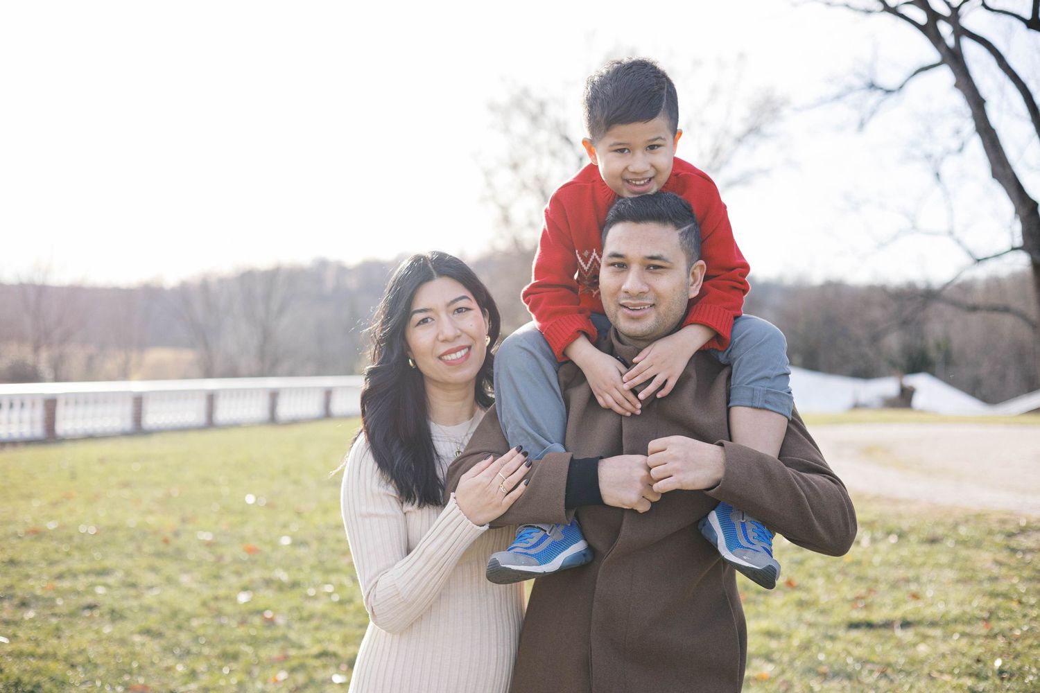 A playful moment captured between family members in an outdoor setting.