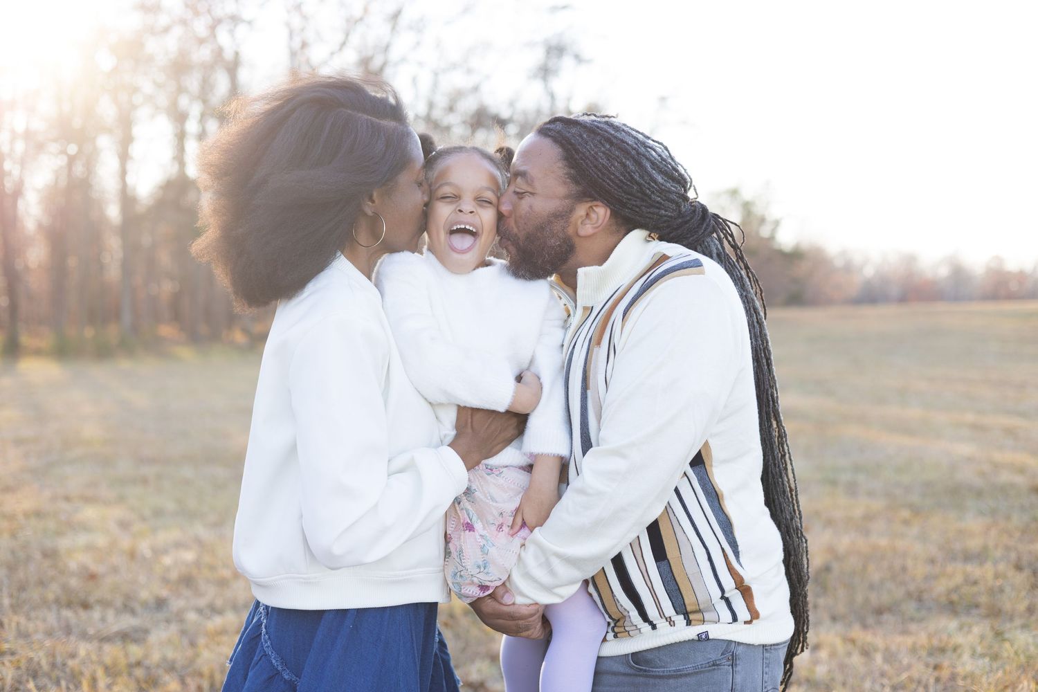 Family sharing joyful moments together outdoors during golden hour.