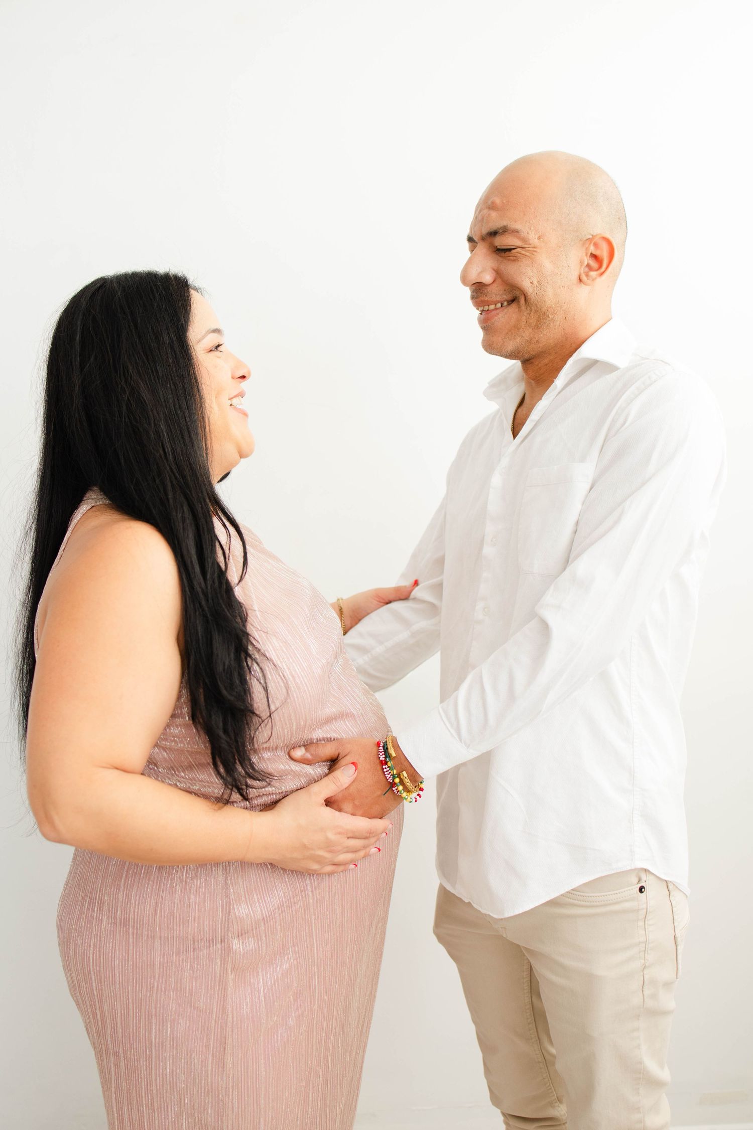 Candid maternity photography sequence showing couple's playful interaction.