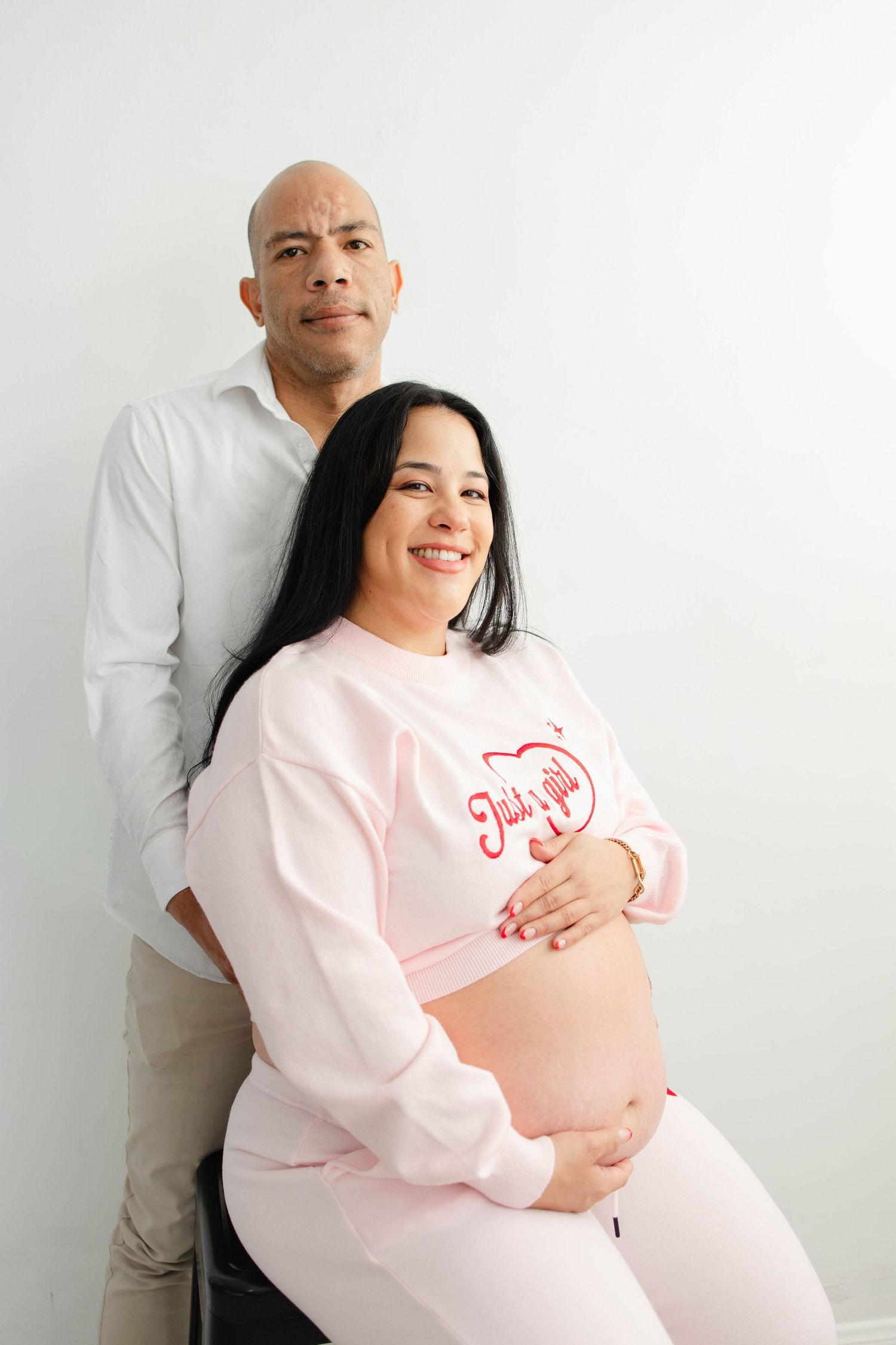 Casual maternity photos showing joyful moments between expectant parents.