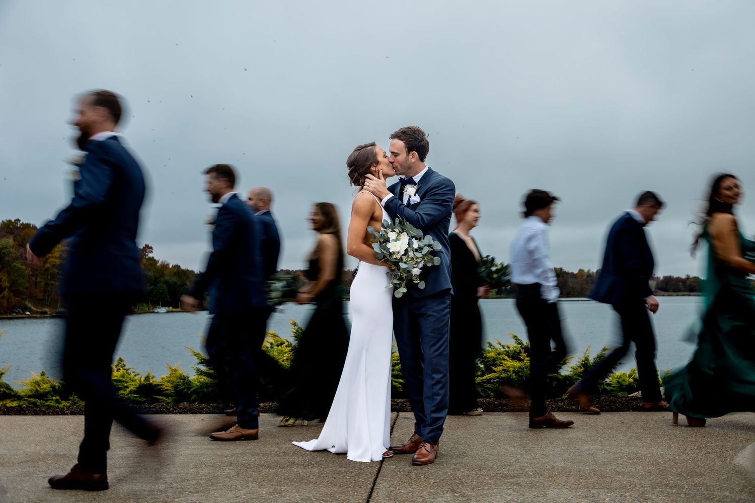 Creative wedding photo with bridal party walking in motion blur background.