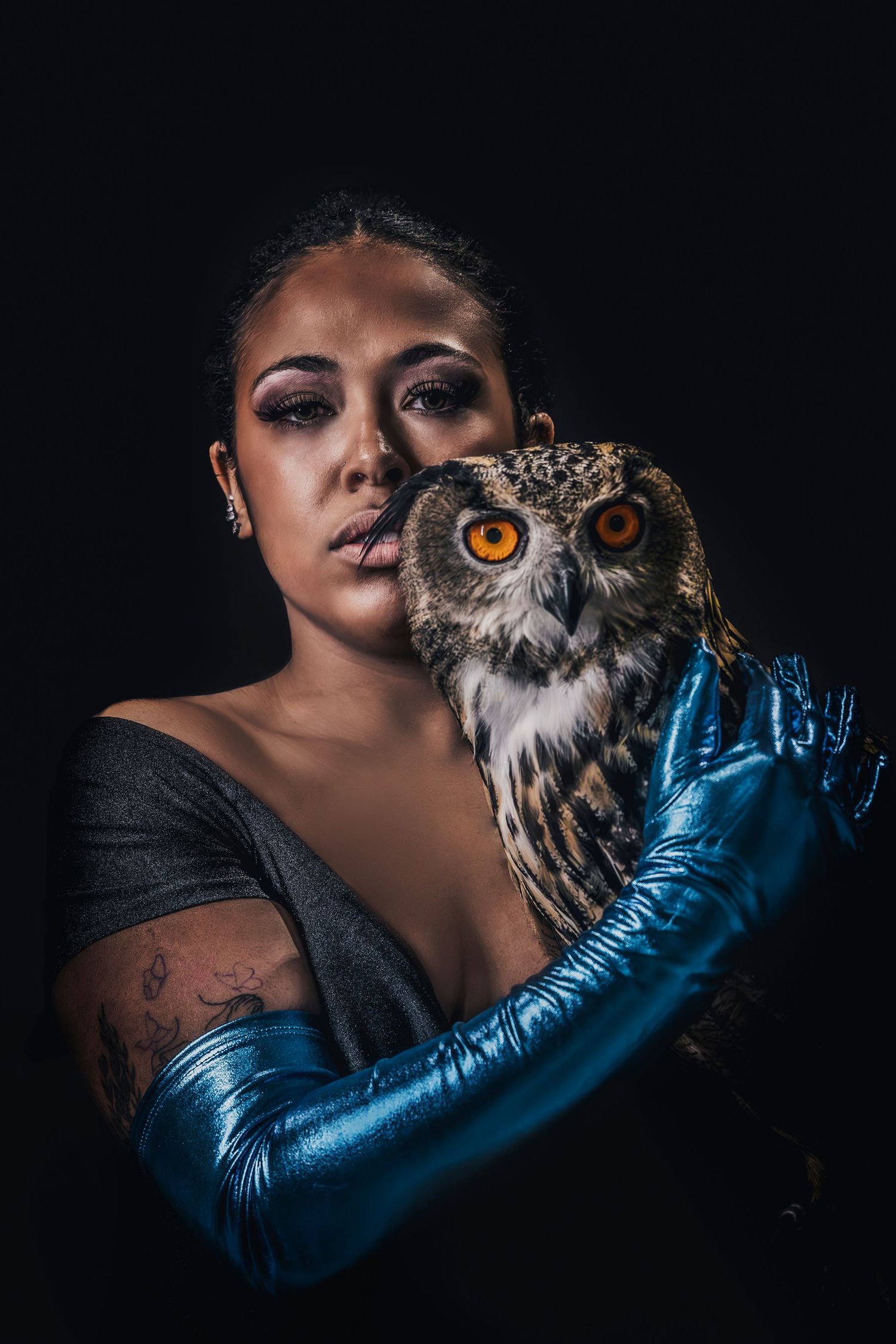 Artistic portrait series featuring an owl with striking orange eyes against a dark background. Wildlife Command Center