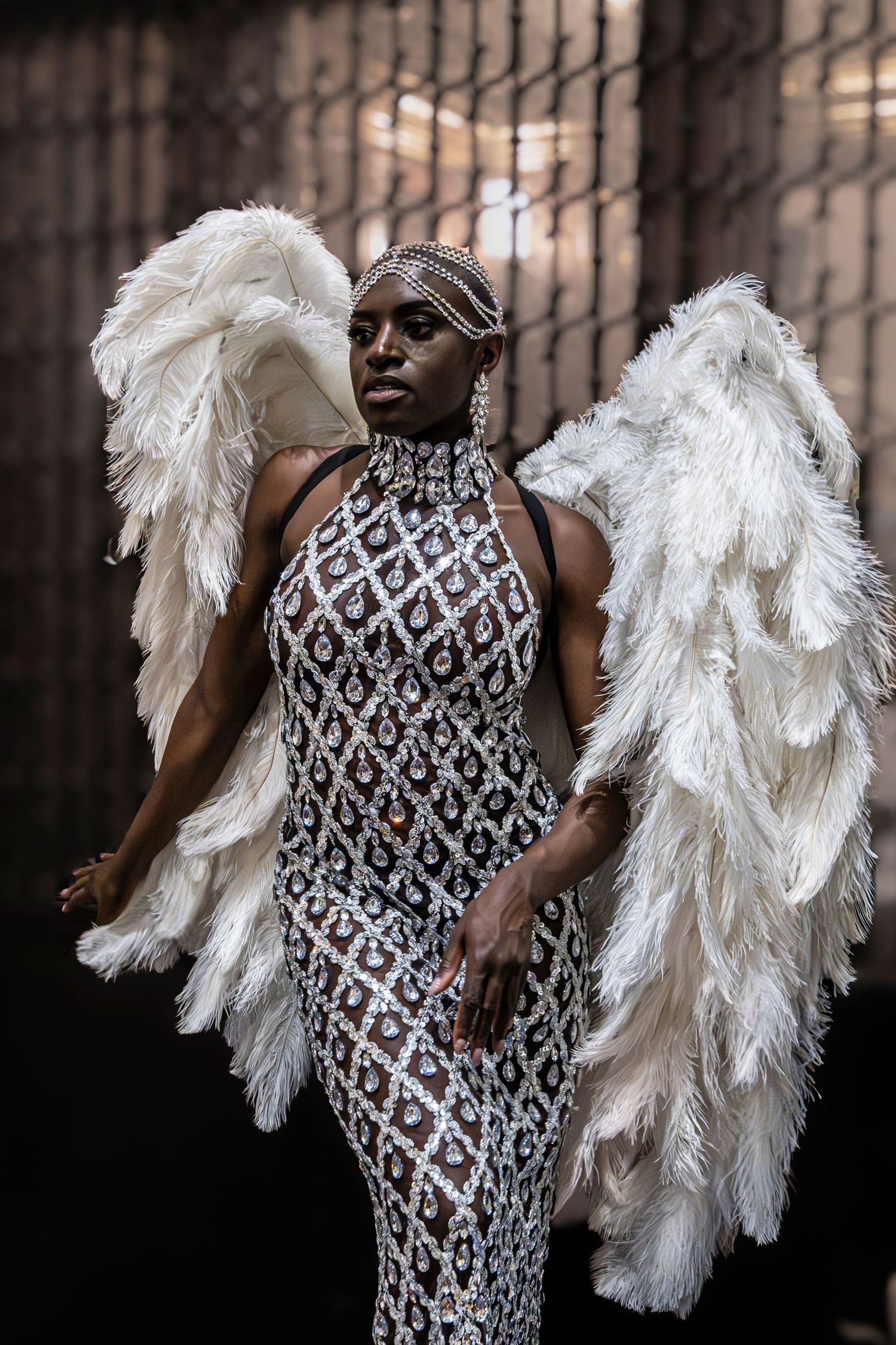 Elegant fashion shoot featuring sequined dress and dramatic white feather accessories.