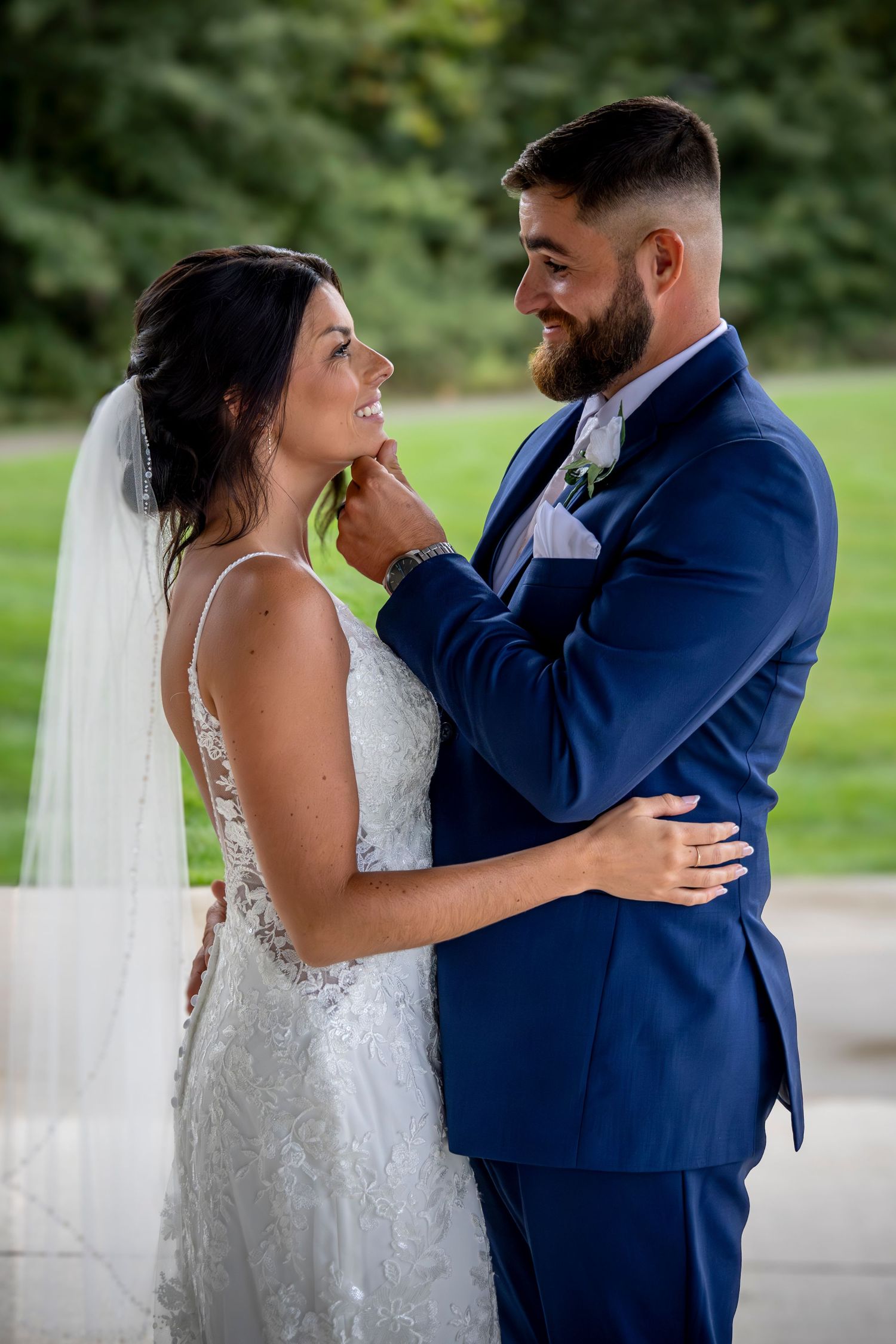 Romantic wedding couple shares intimate moments in an outdoor setting.