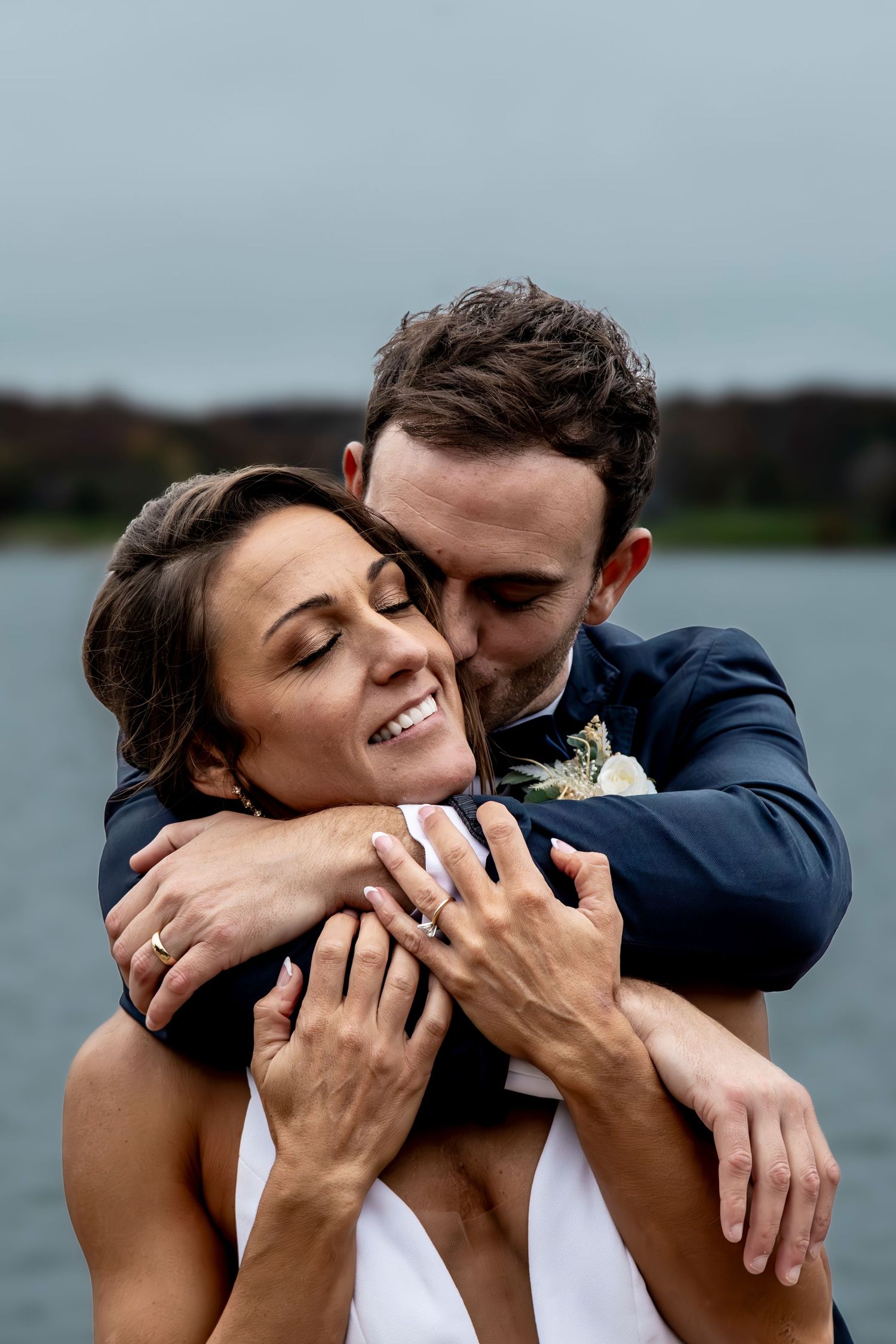Candid wedding moments captured by the water with joyful expressions.
